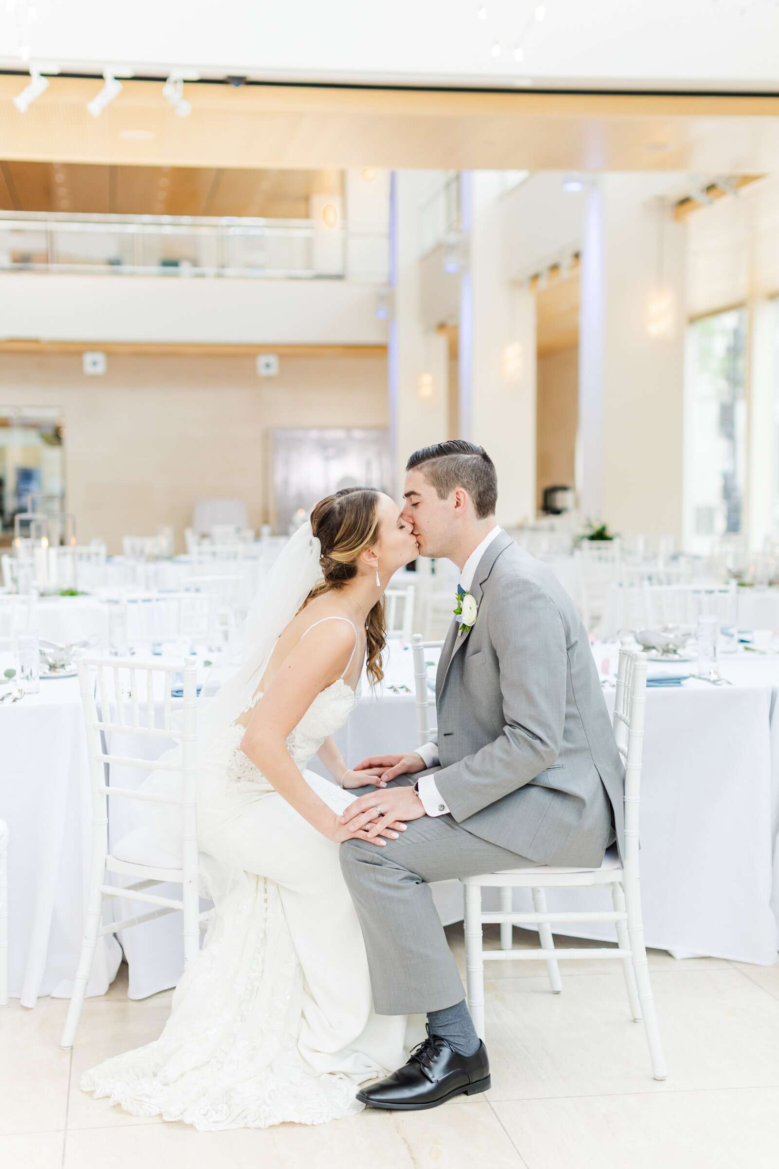 32_bride_and_groom_kissing_white_seated_at_the_overture_center_madison_wisconsin