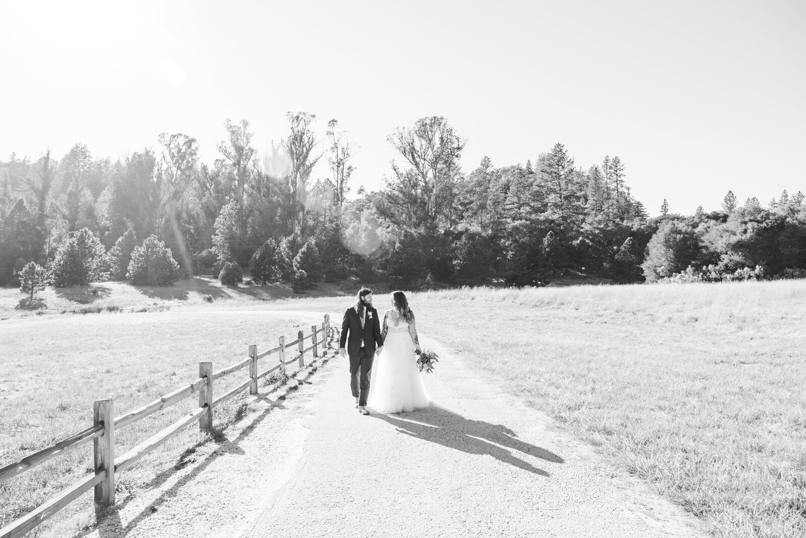 Tattoo bride and groom embrace on their colorful wedding day in Santa Cruz, California.