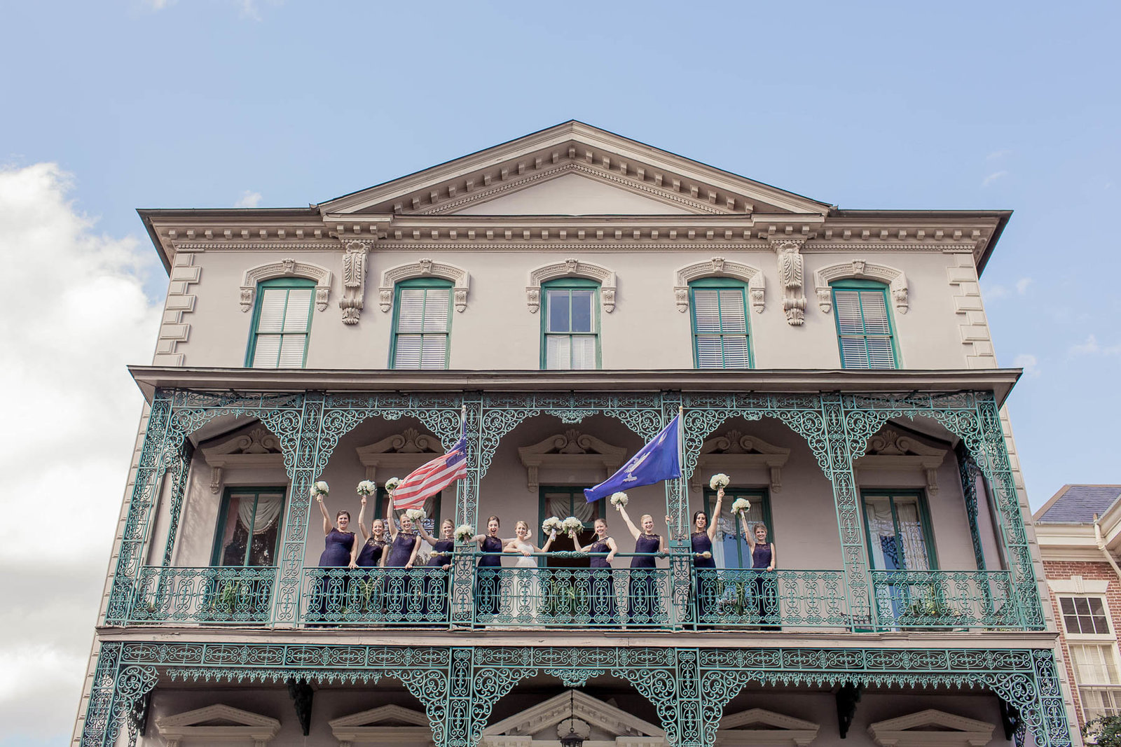 Bride and bridesmaids pose on balcony, John Rutledge House Inn, Charleston, South Carolina. Kate Timbers Photography.