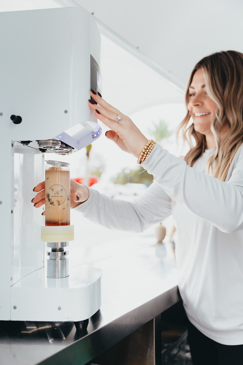 female mixing an iced coffee drink