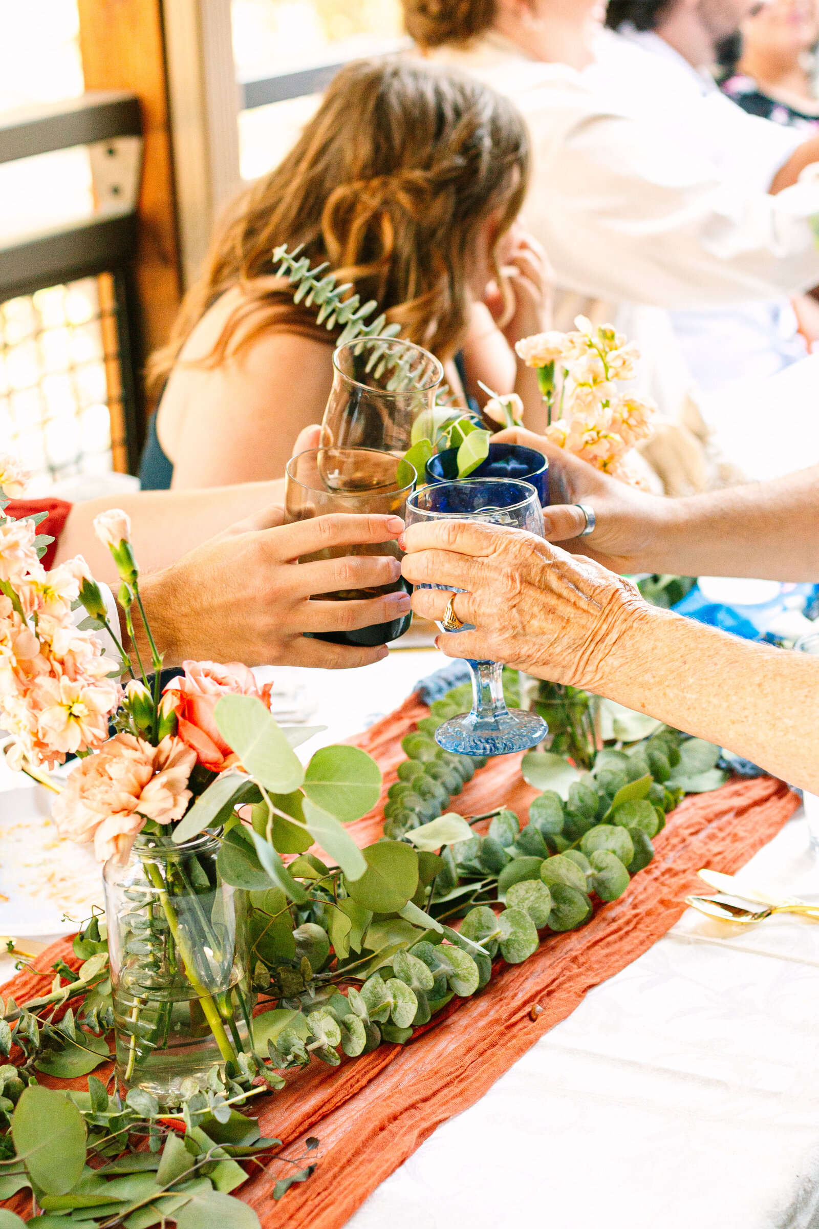 The bridal party celebrates an intimate elopement at a cabin at Big Bear Lake, California.