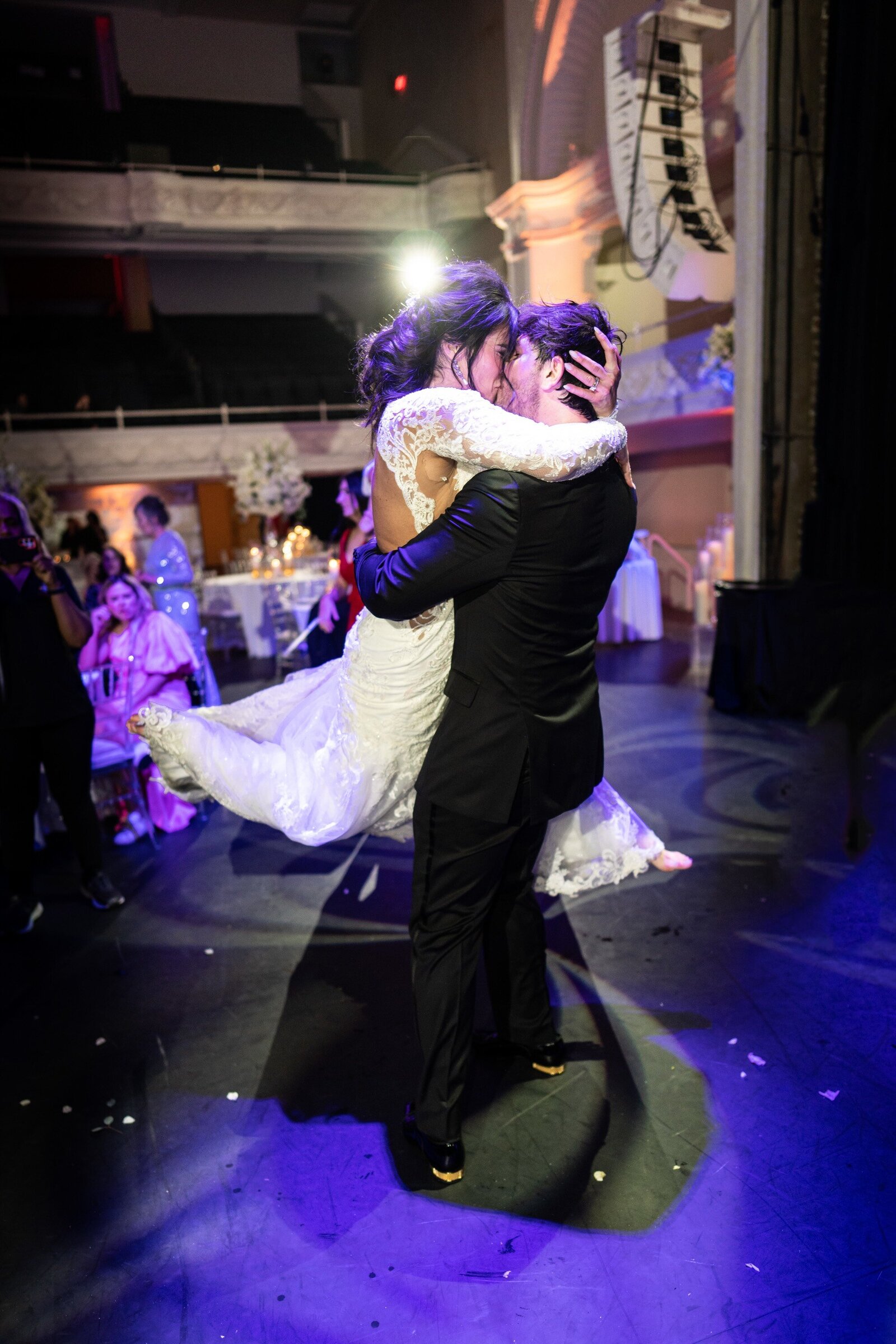 Groom lifts bride at Civic Theatre wedding reception