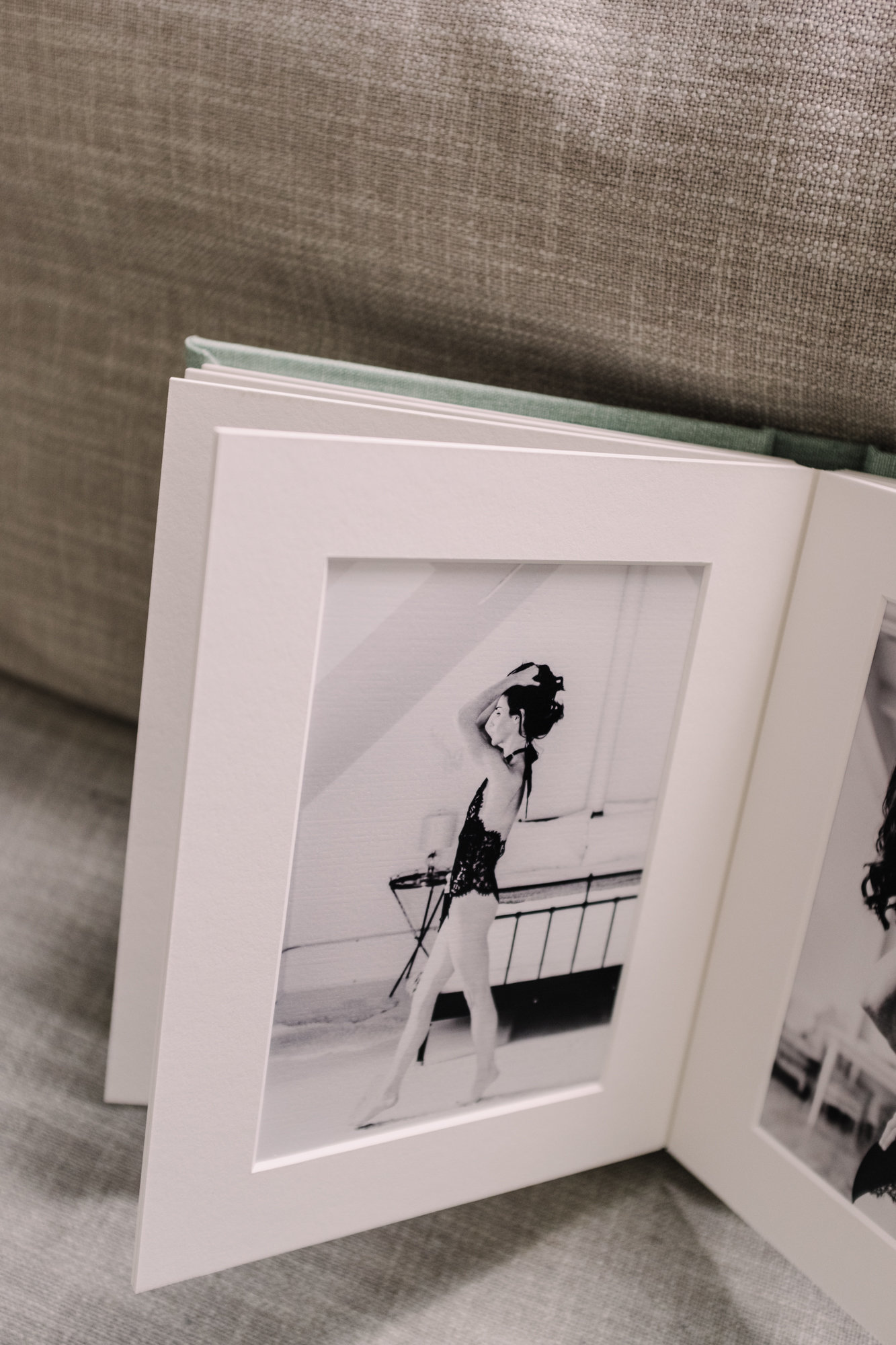 A matted boudoir album featuring black and white prints