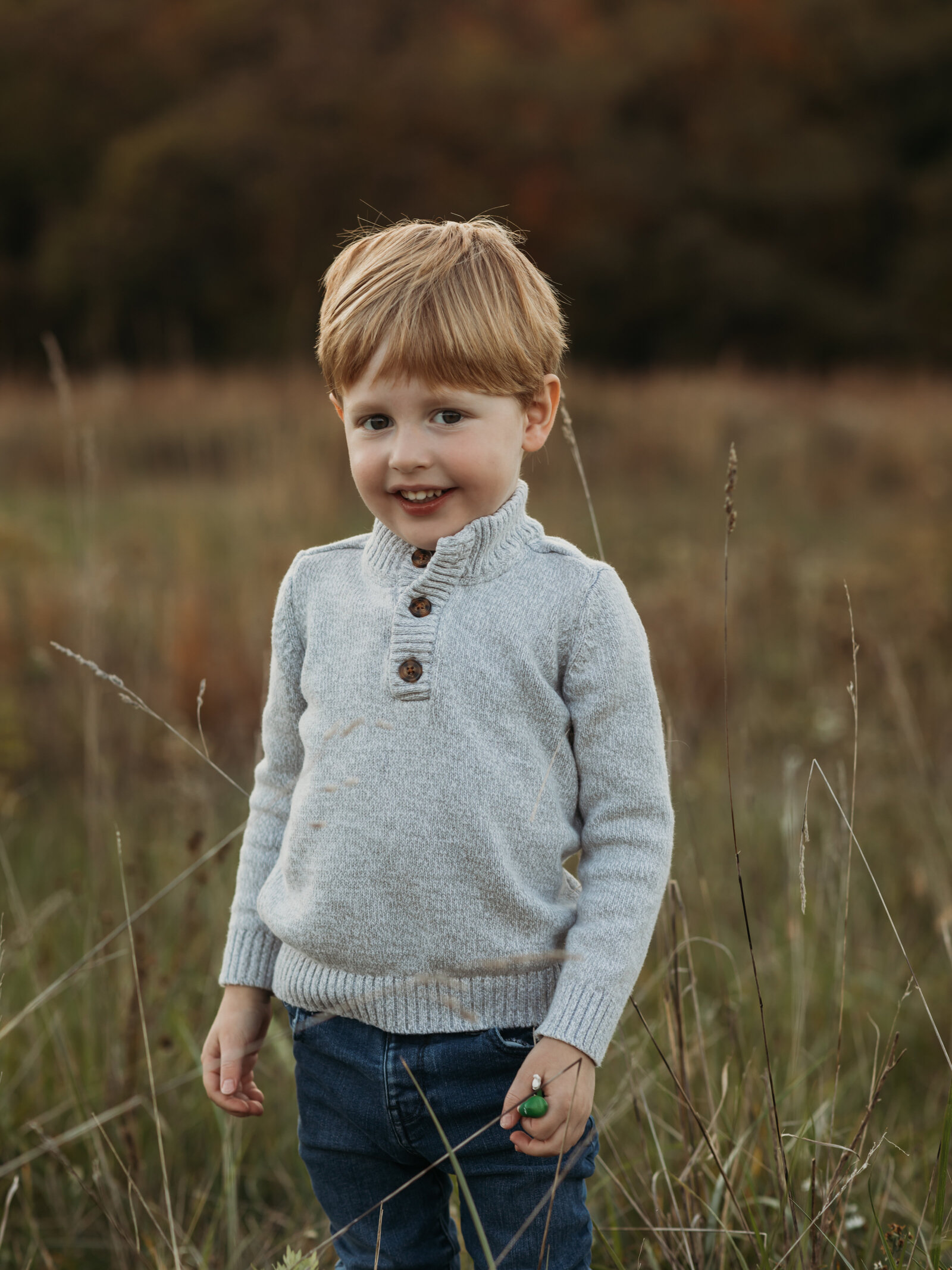 boy in gray sweater posing for family photos cleveland family photography