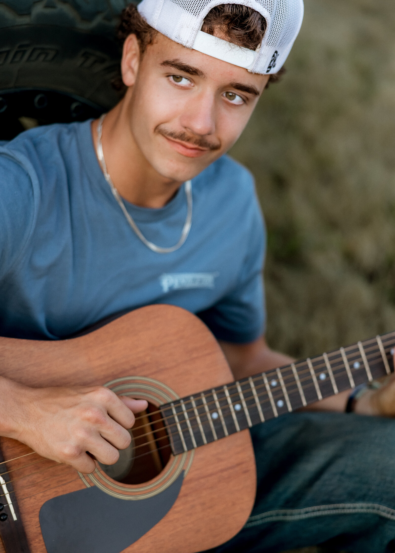 Sam Barlow High School Senior taking senior portraits with his guitar at Milo Mciver Park