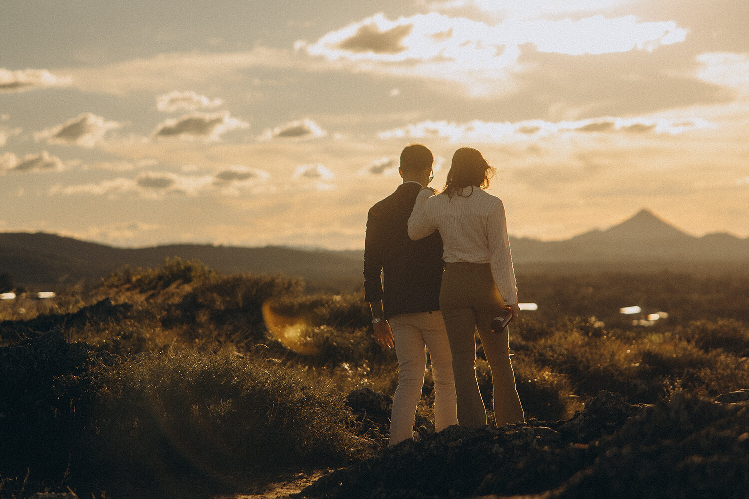 Couple standing together on a hill at sunset during a storytelling session with a Sunshine Coast photographer