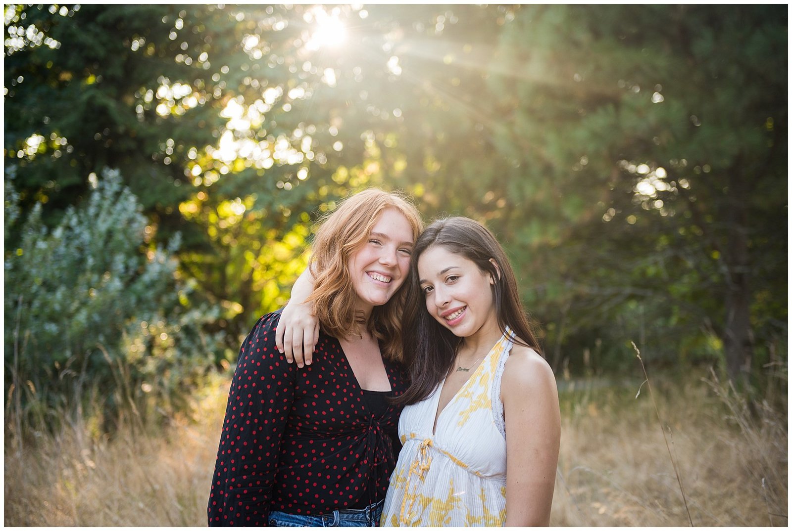 Two Senior Graduating Girlfriends in field at sunset Emily Ann Photography Seattle Photographer