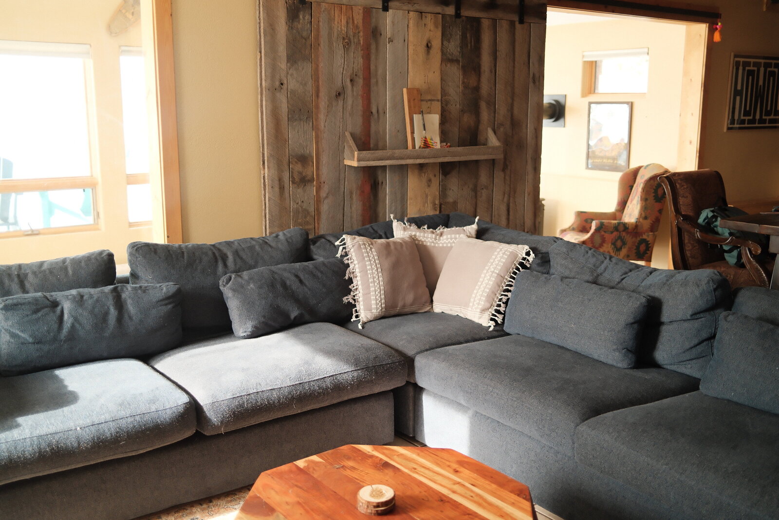 Blue couch with gray accent pillows
