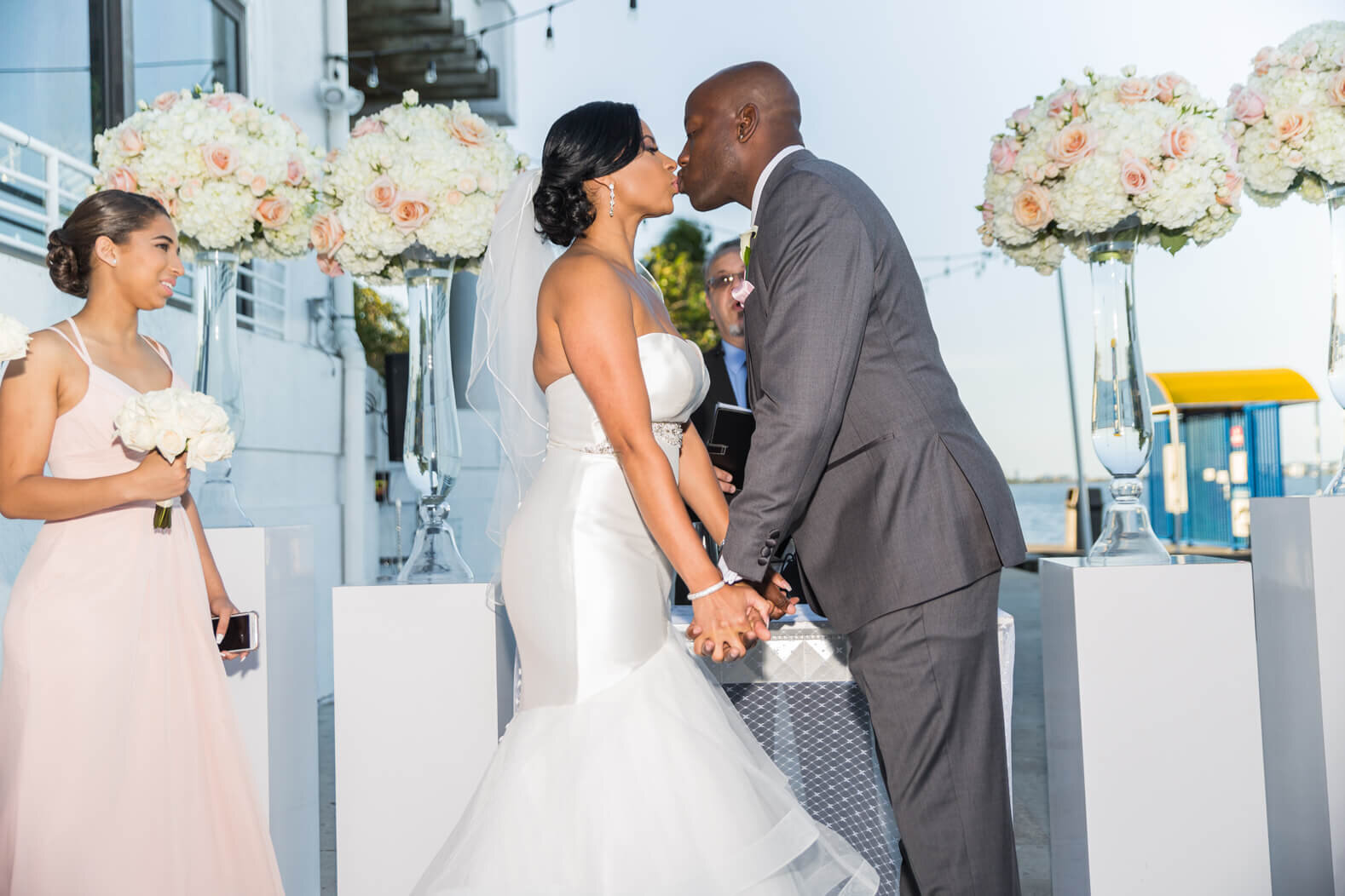 bride-groom-first-kiss-miami-biscayne-bay-briza-on-the-bay-venue-