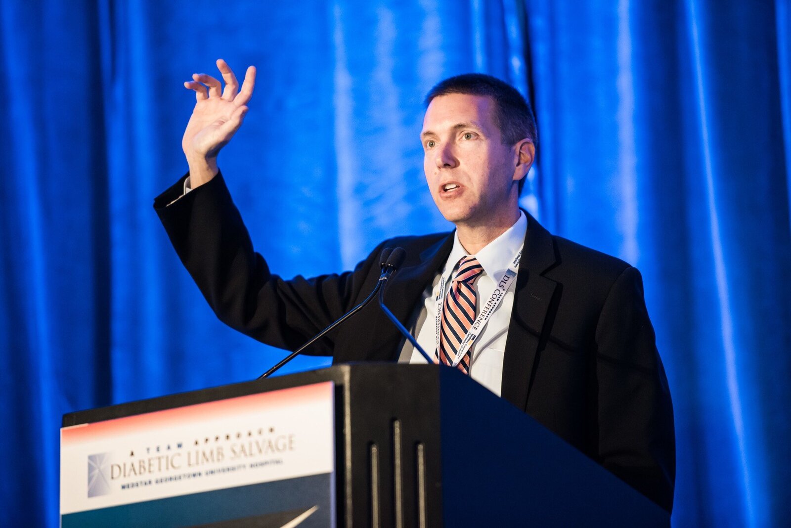 Medical convention presenter at podium