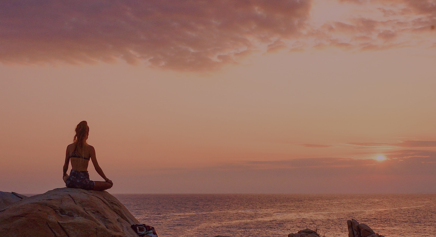 Woman meditating during sunrise section blog image