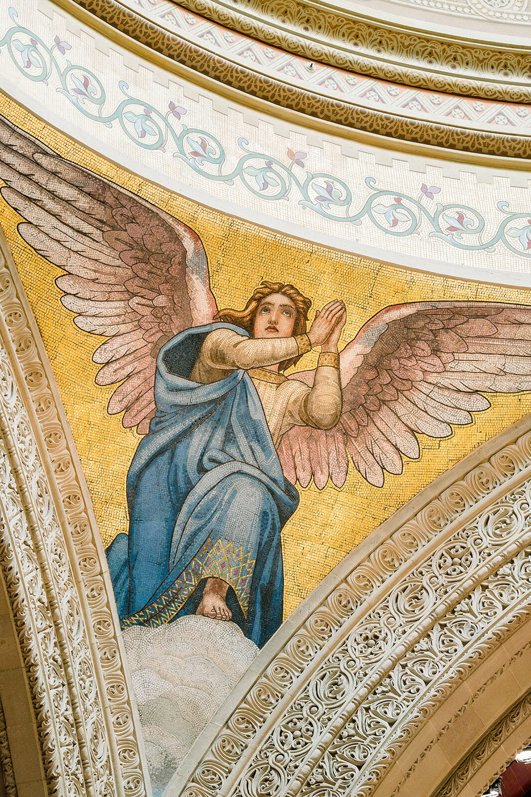 A striking portrait of the groom standing against the beautiful mural at Stanford Memorial Church, capturing the essence of the venue.