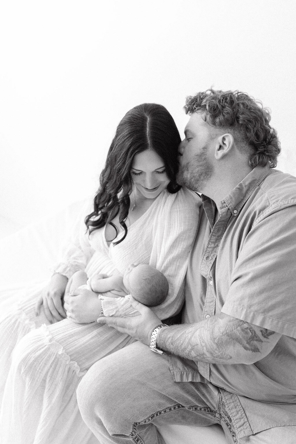 Mom and dad holding newborn baby during Grand Forks photography session
