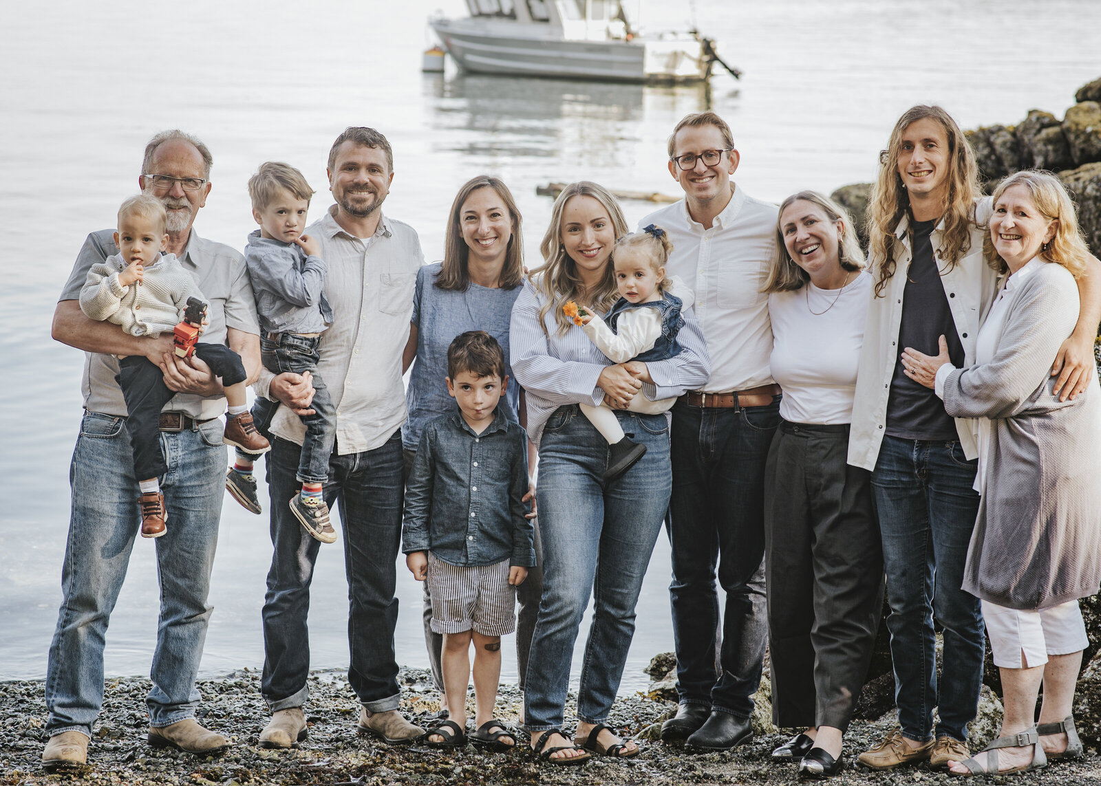 Family of 12 with three generations standing by the shore
