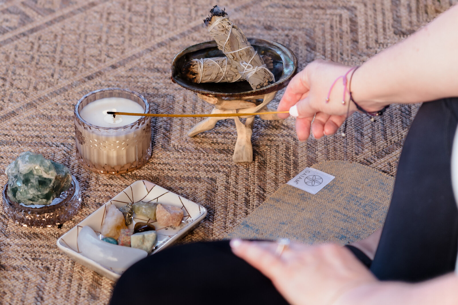 detail shot of meditation props - candle, sage, crystals