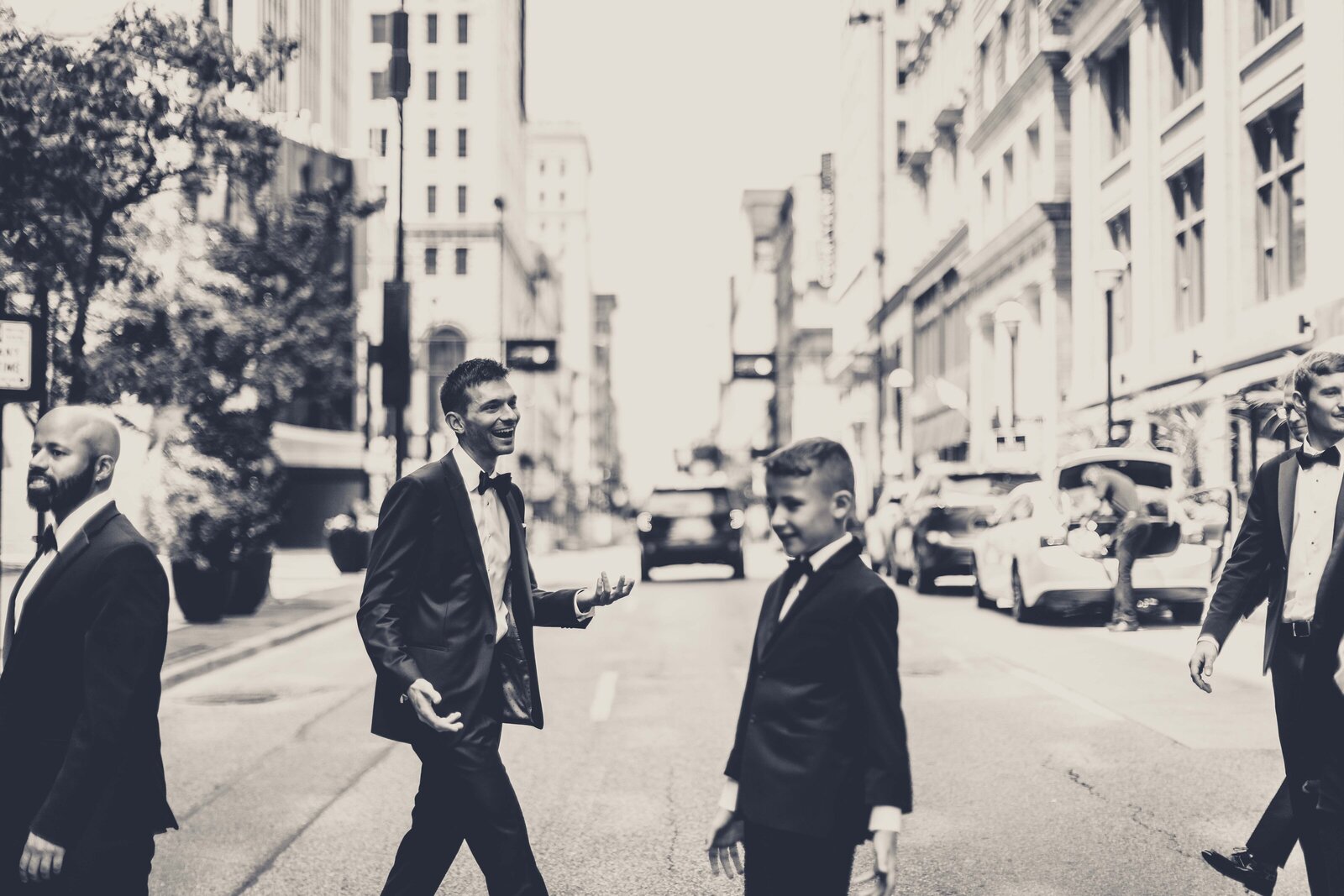 Capture the cool and confident swagger of the groomsmen as they stride through the bustling streets of downtown Cincinnati. This dynamic photograph showcases the group's sharp attire and the vibrant urban backdrop, reflecting a modern take on traditional wedding portraits. Perfect for couples looking for unique and spirited wedding party photos, this image combines the excitement of the city with the celebratory spirit of the wedding day.
