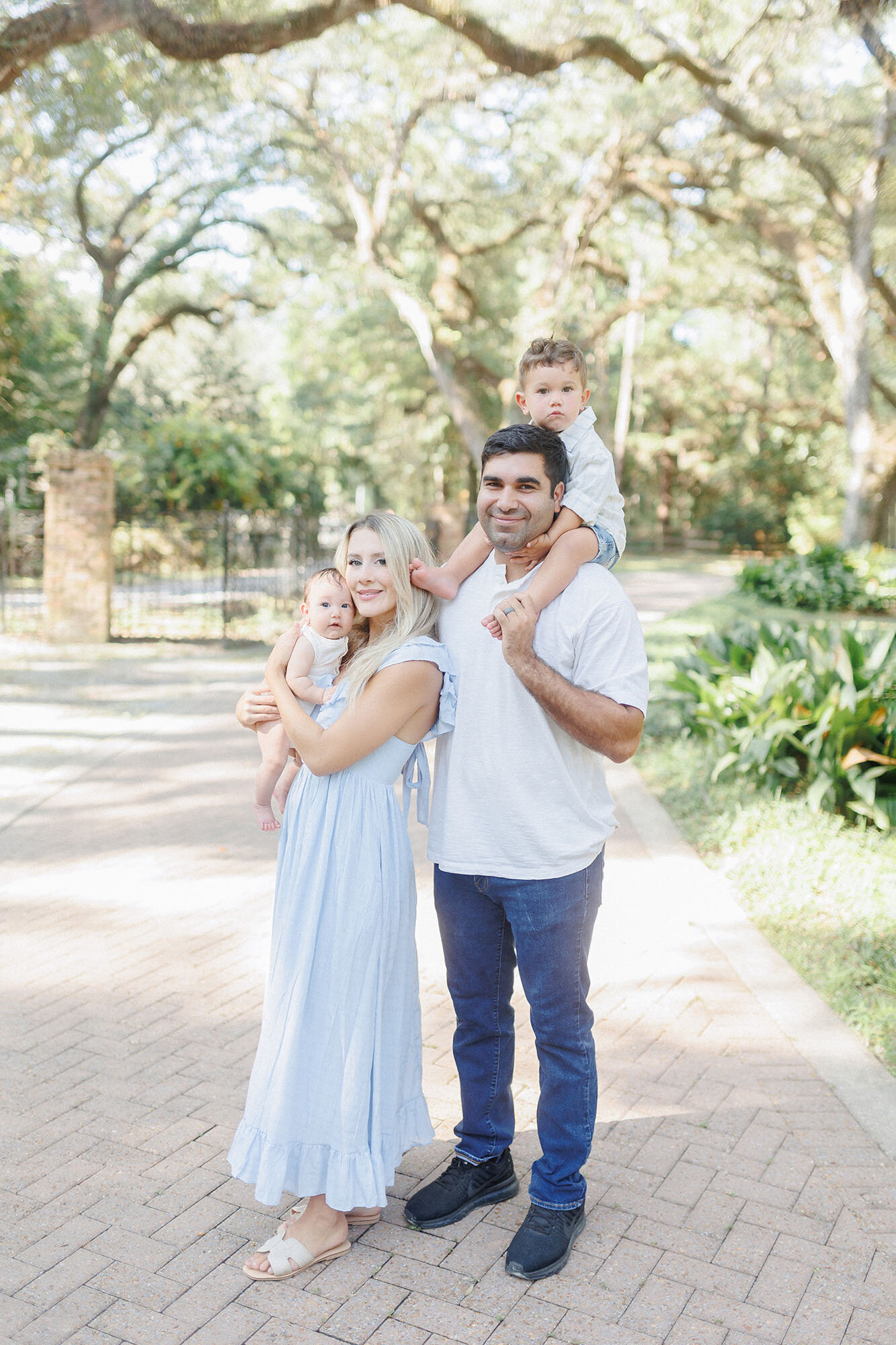 A family of four smiling at the camera during their photo session at Turtle River State Park