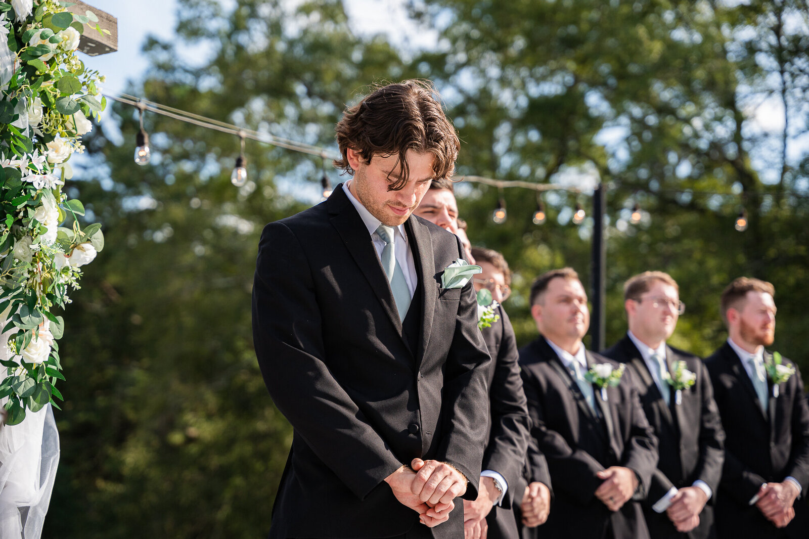 Zach awaiting his bride walking down the aisle at the wedding ceremony at the Venue Daisy Hill wedding venue in Georgia