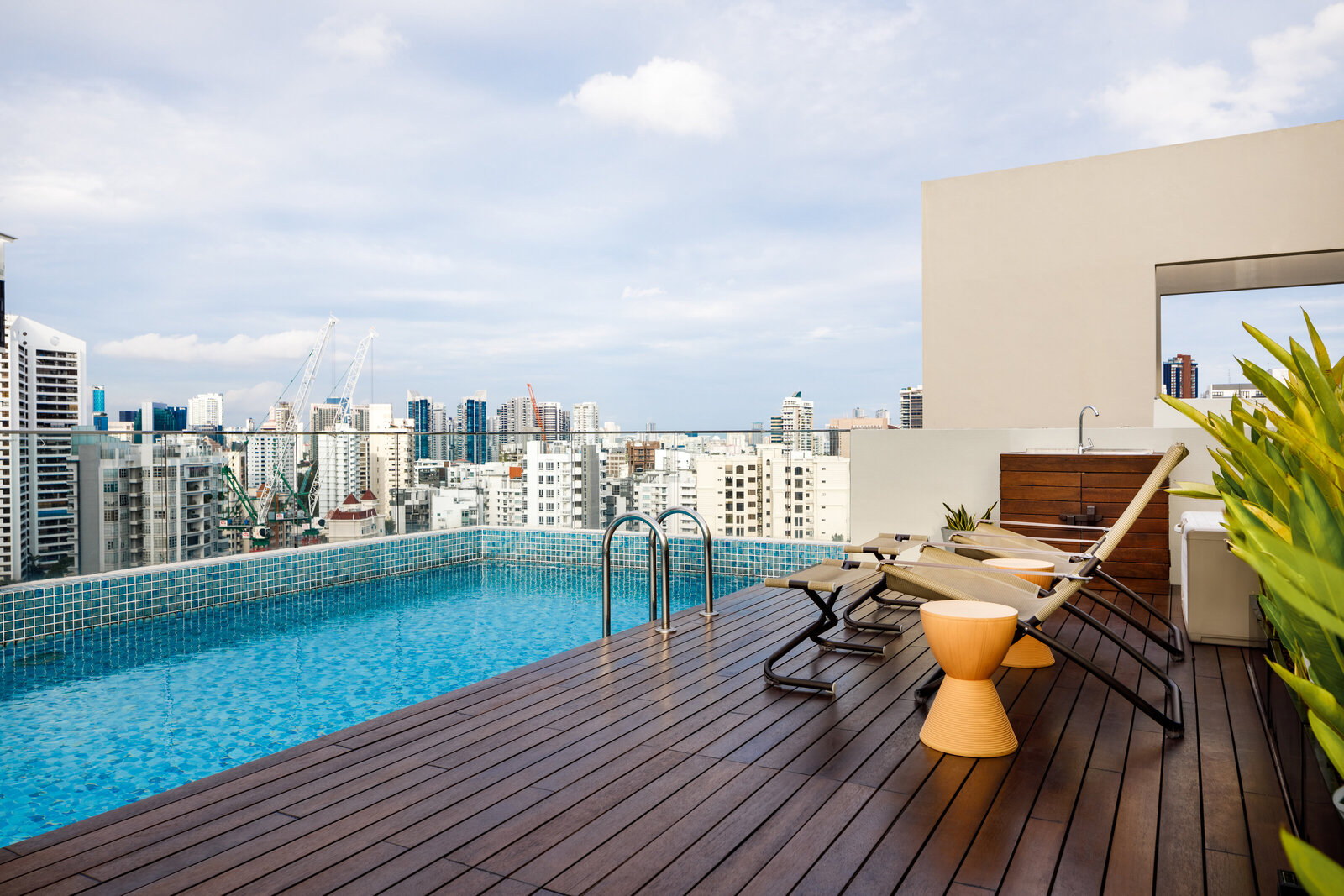 lap pool with deck chairs and skyline