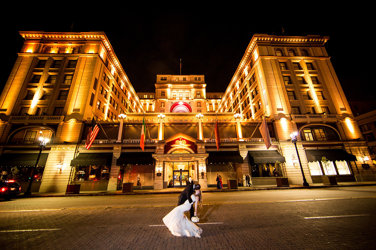 night shot with bride and groom with us grant hotel in background
