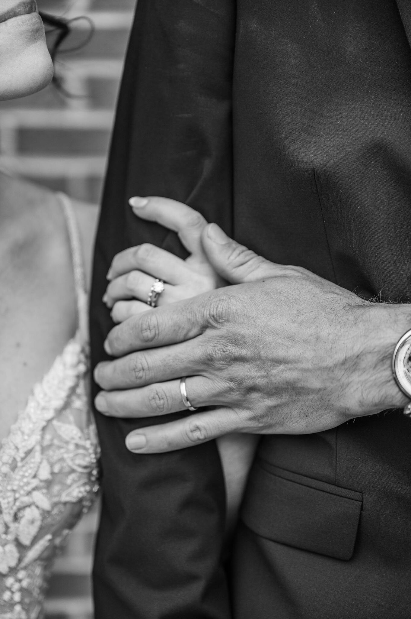 Bride and groom hands with their wedding ring