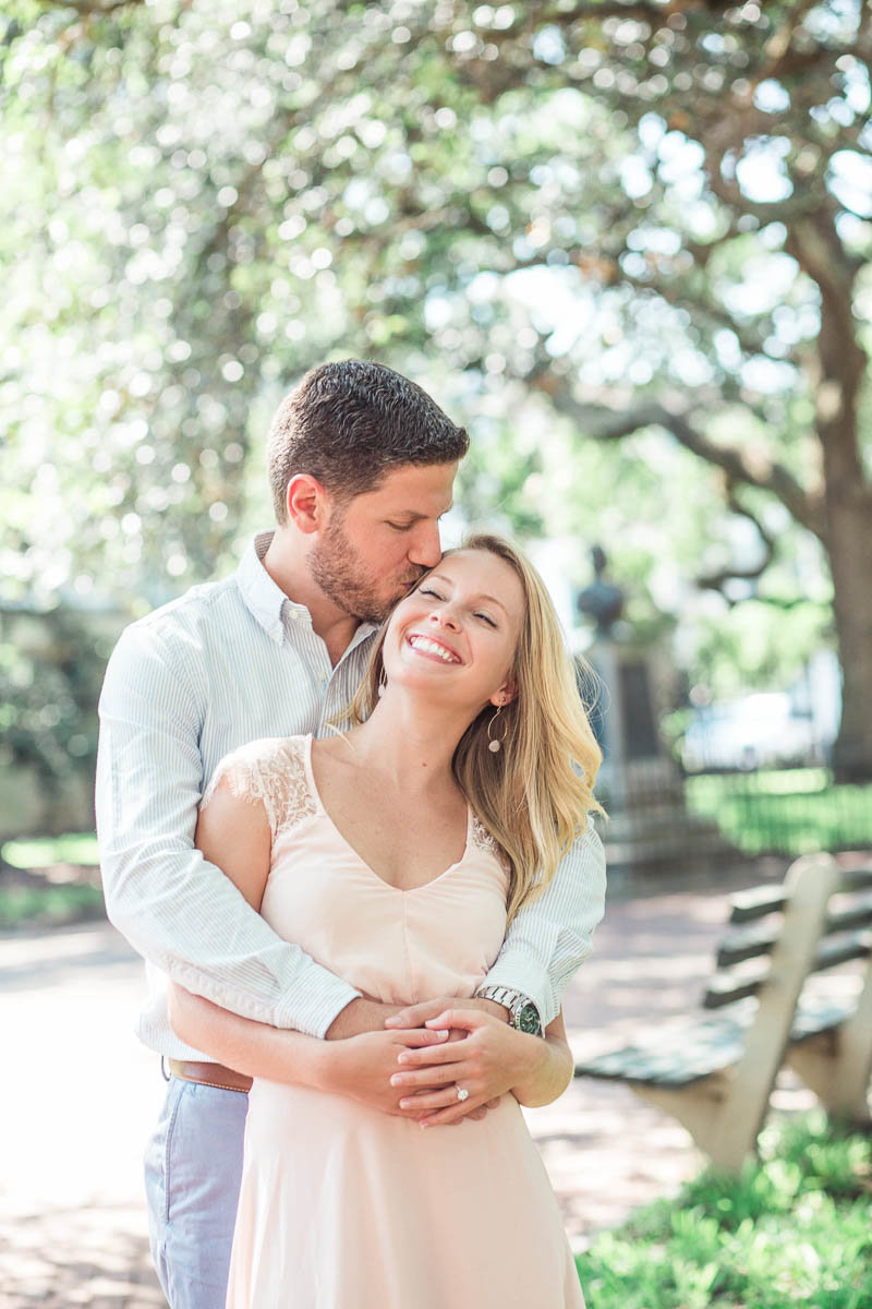 Engaged couple snuggles under oak trees, Downtown Charleston, South Carolina