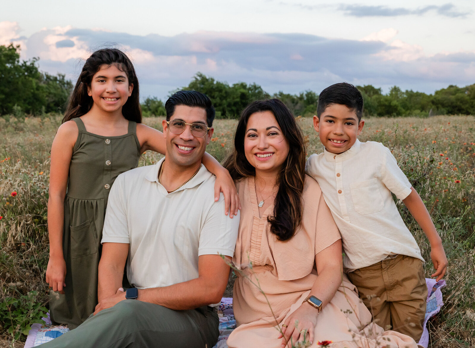 family posing in flowers