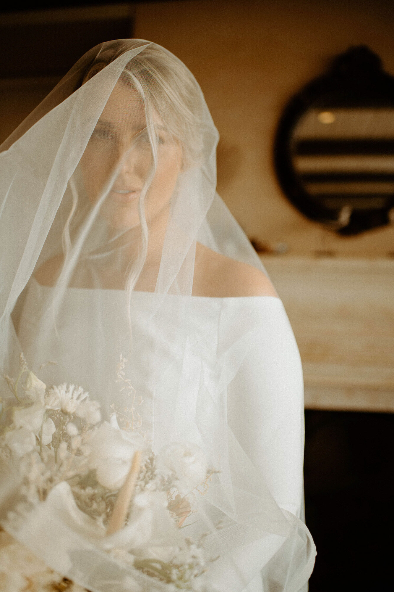 Bride holding a bouquet of flower and wearing her veil