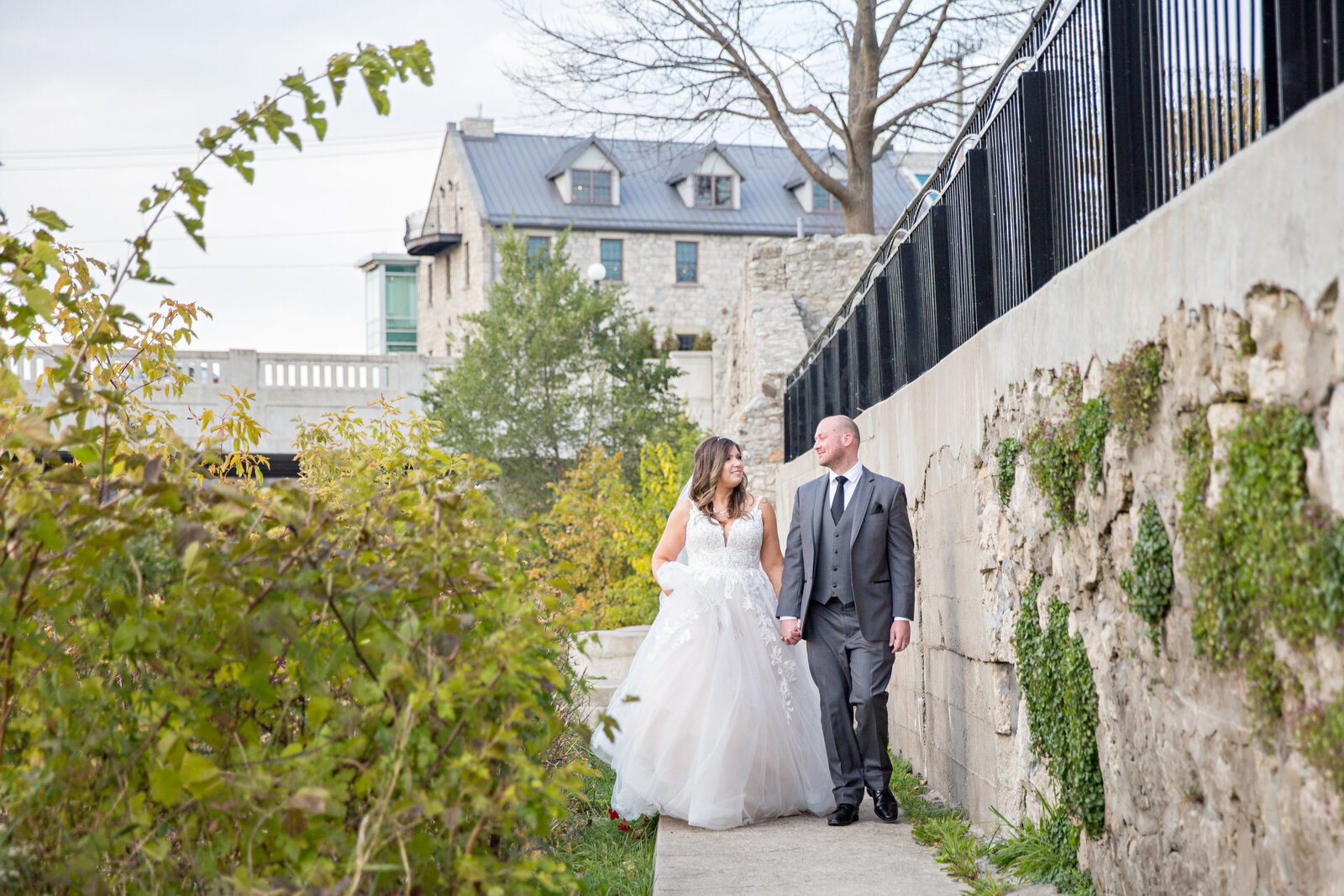 bride and groom walking Cambridge Mill