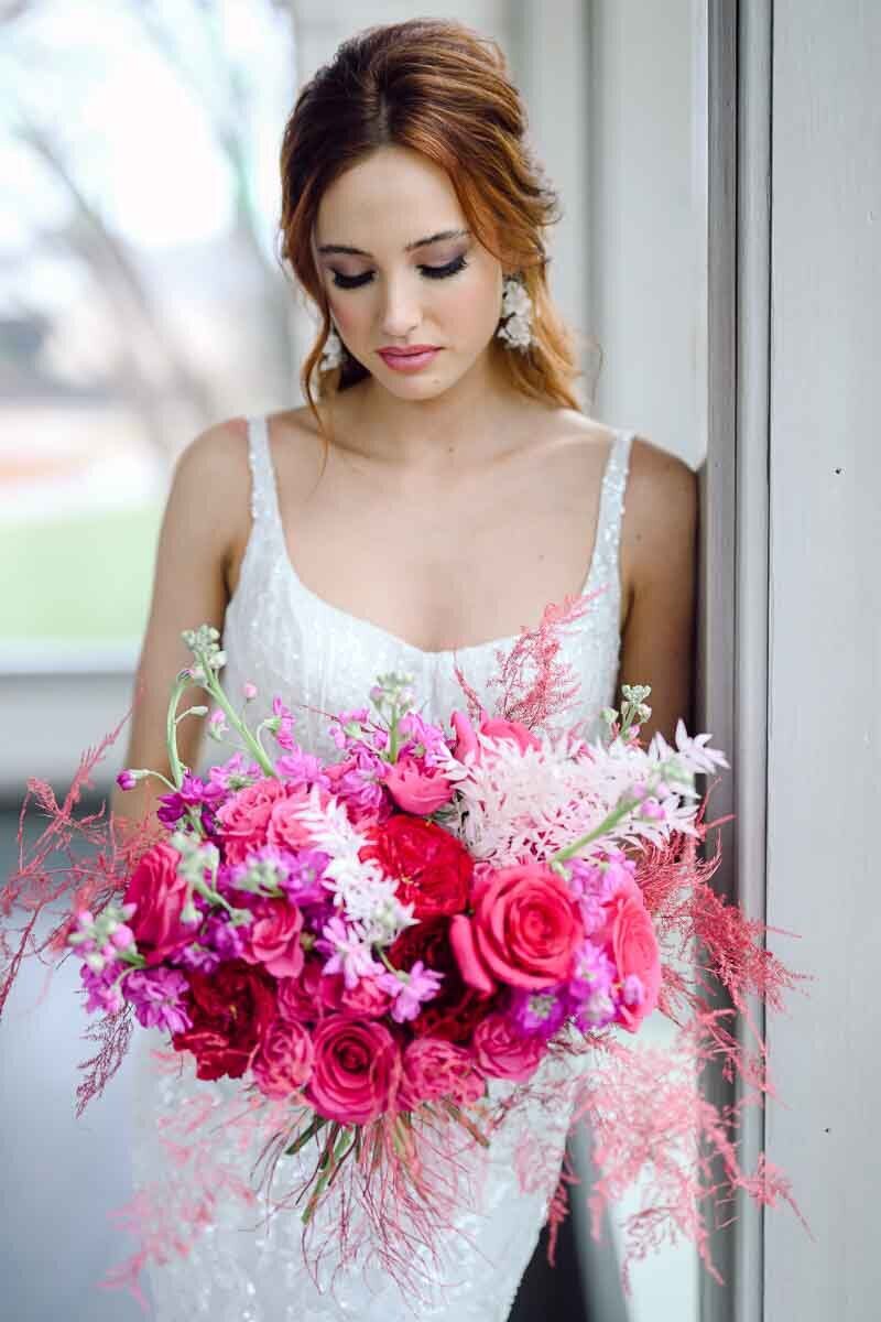 photo of bride holding bright pink bouquet