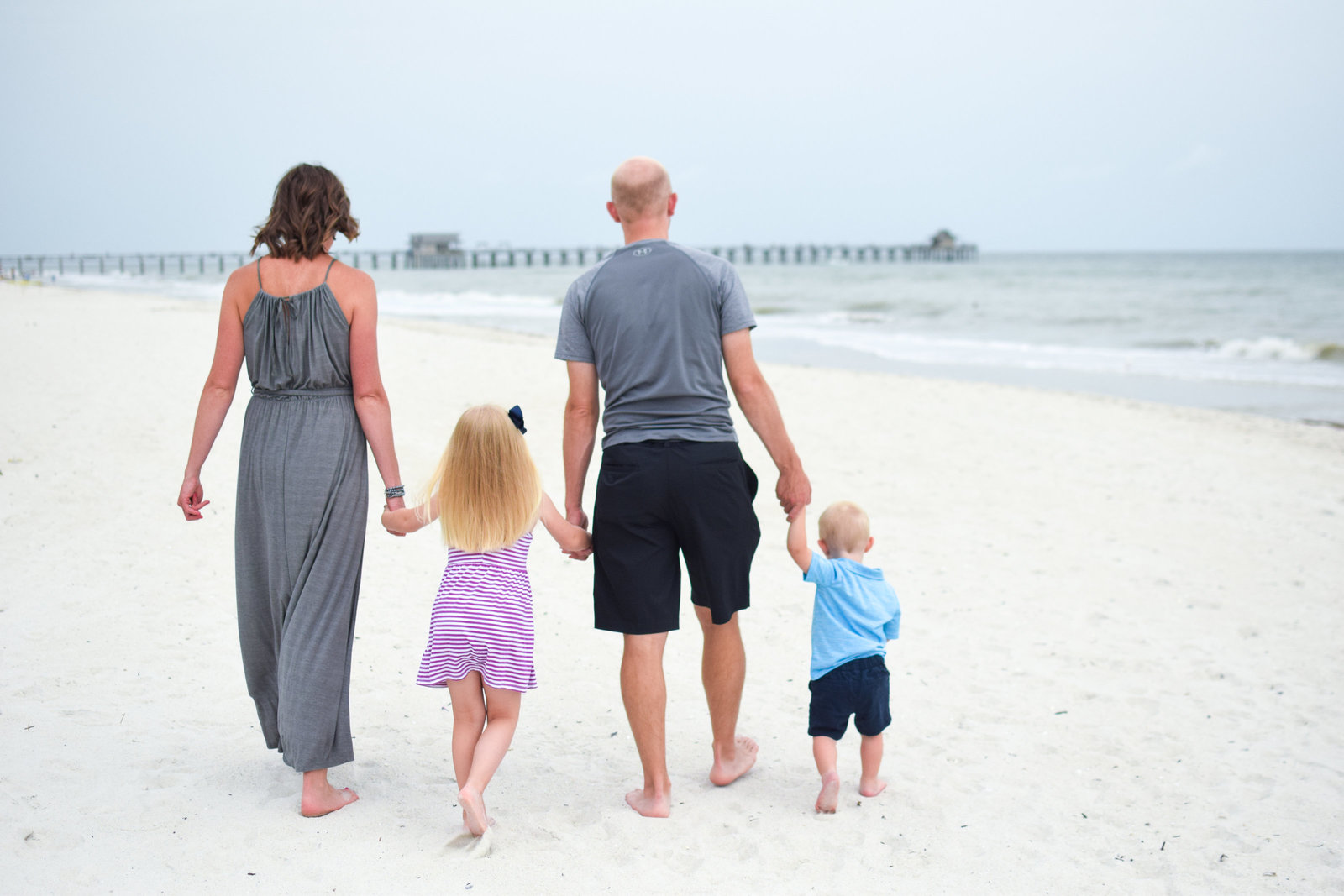 Family walking on beach Naples Florida