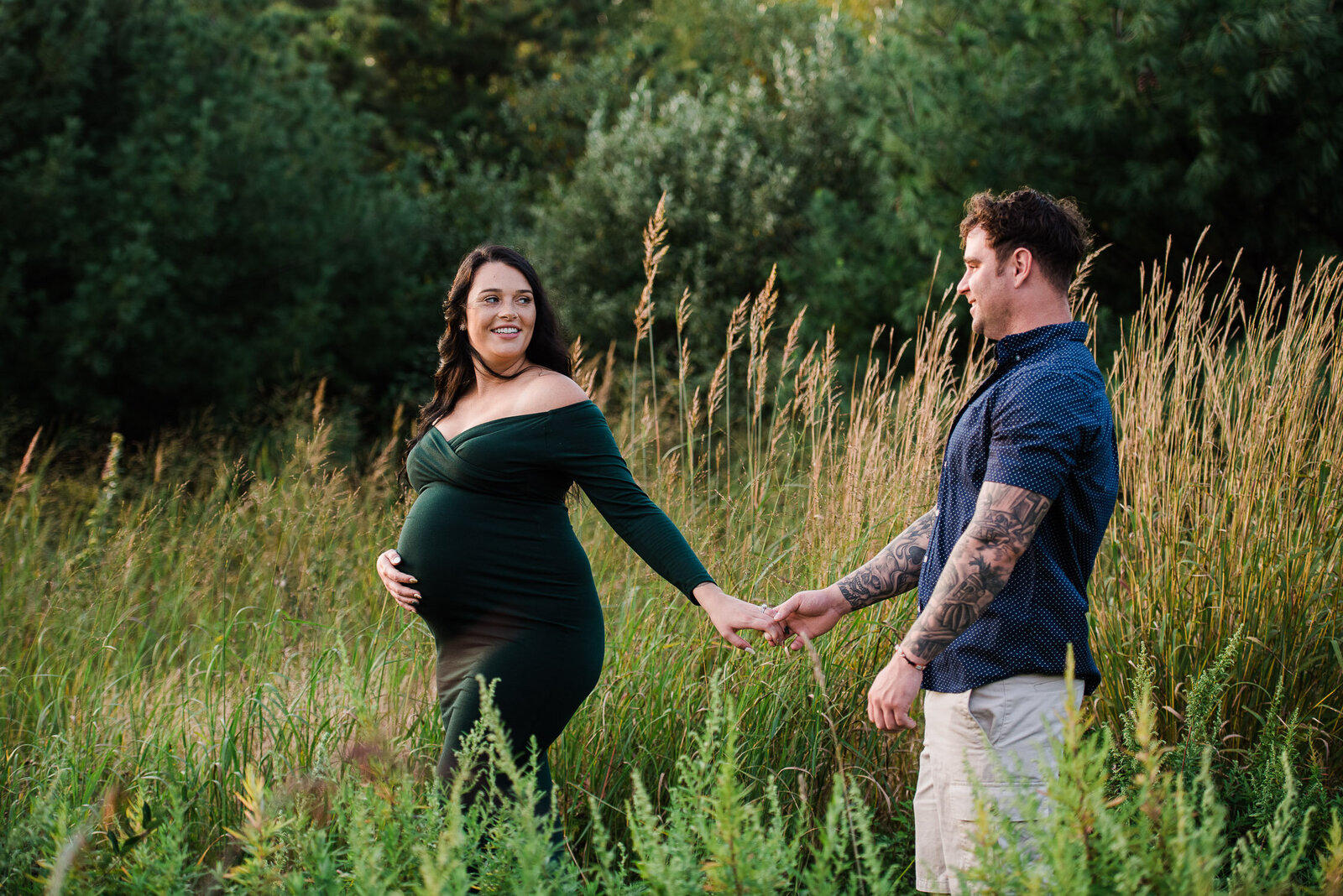 maternity girl walk with boy in long grass