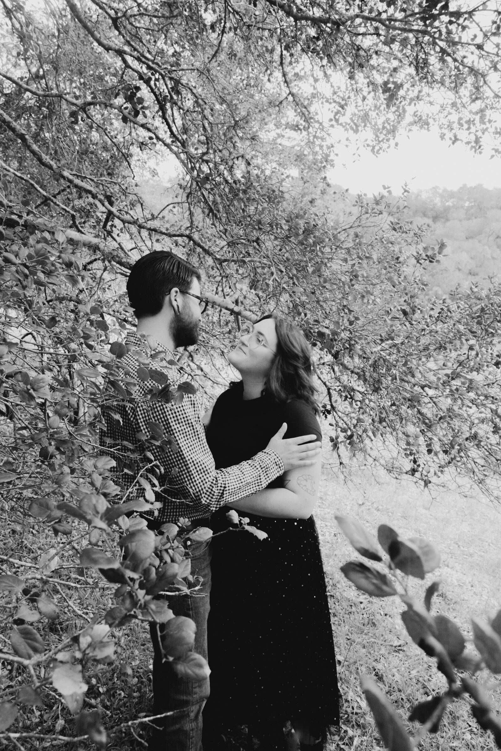 An tattooed engaged couple poses for photos in a redwood forest in Santa Cruz, Ca.