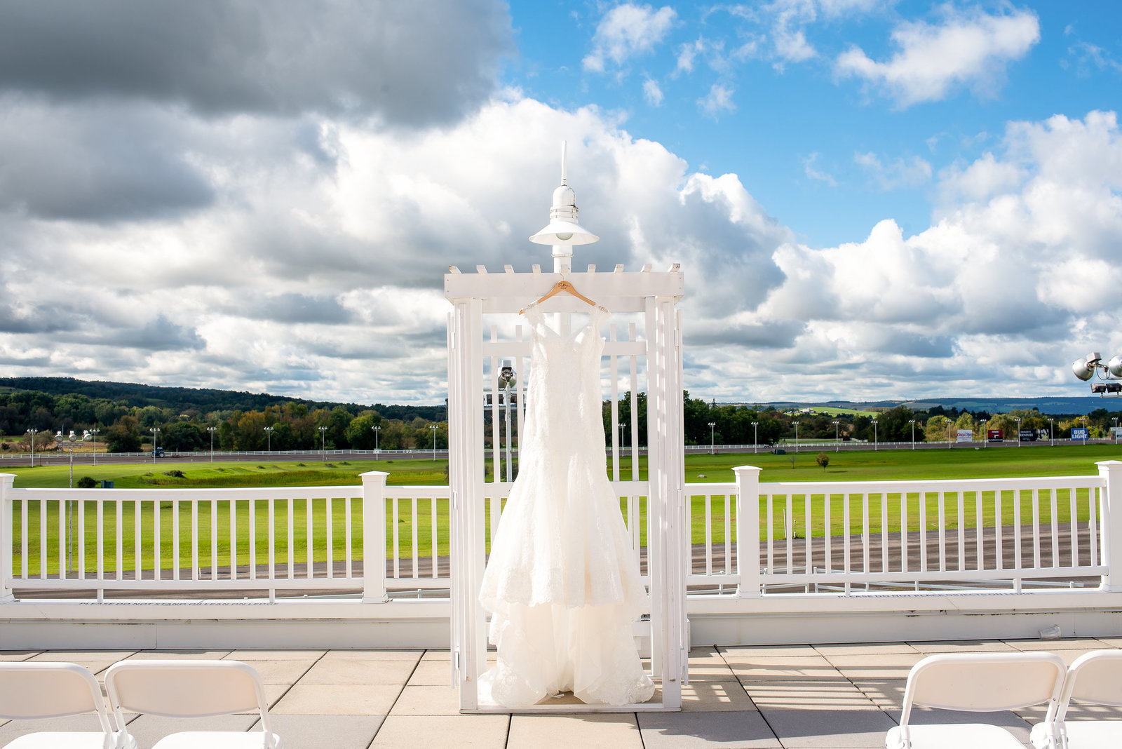 WEdding dress hangs on a  arch at Vernon Downs