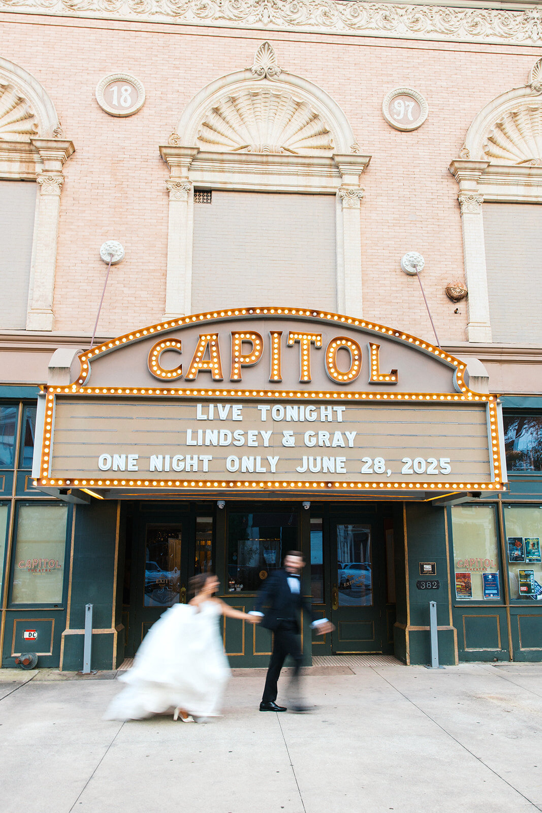 Bride and groom run in front of capitol theatre in macon georgia