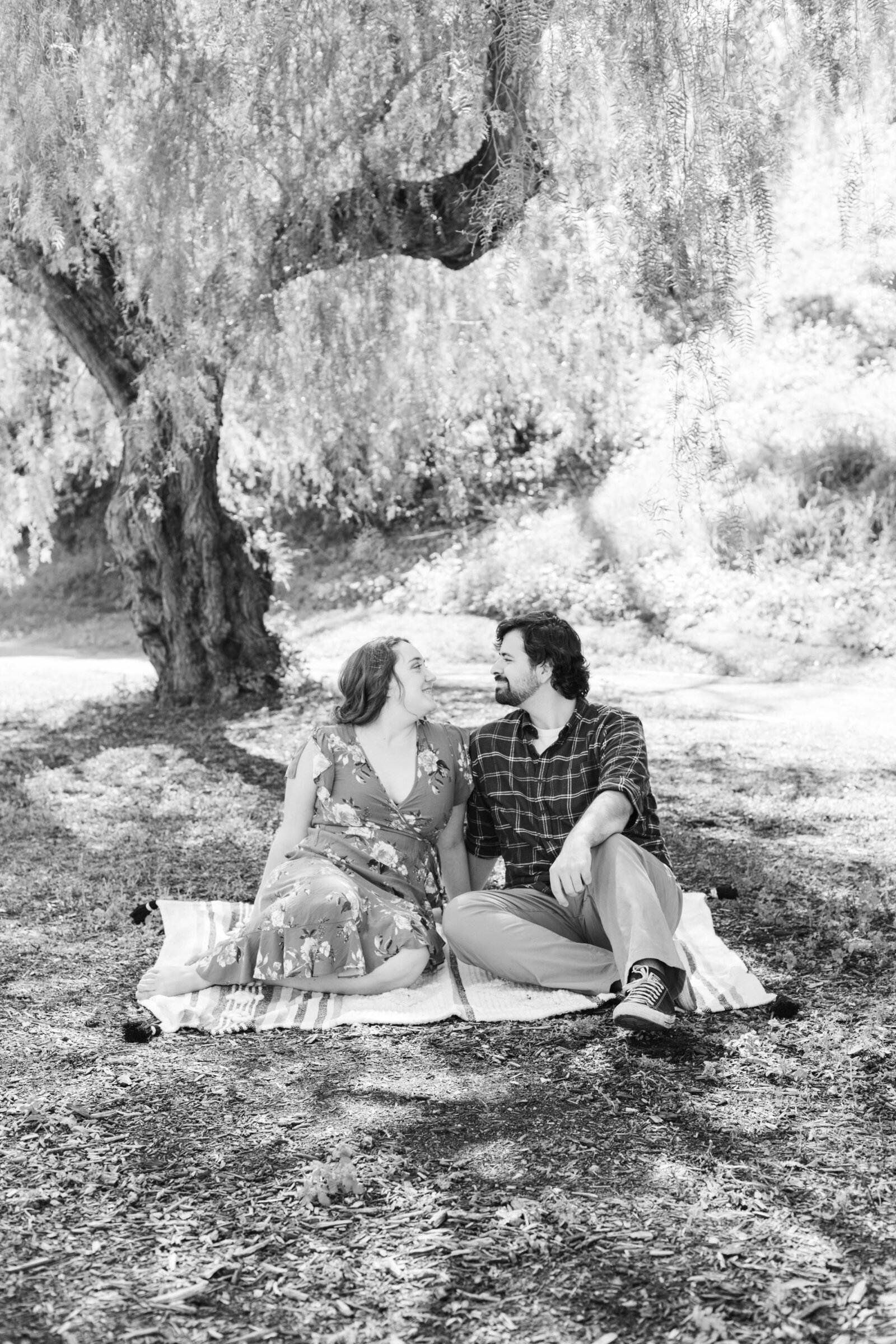 An engaged couple poses for photos in a garden in Los Angeles, Ca.