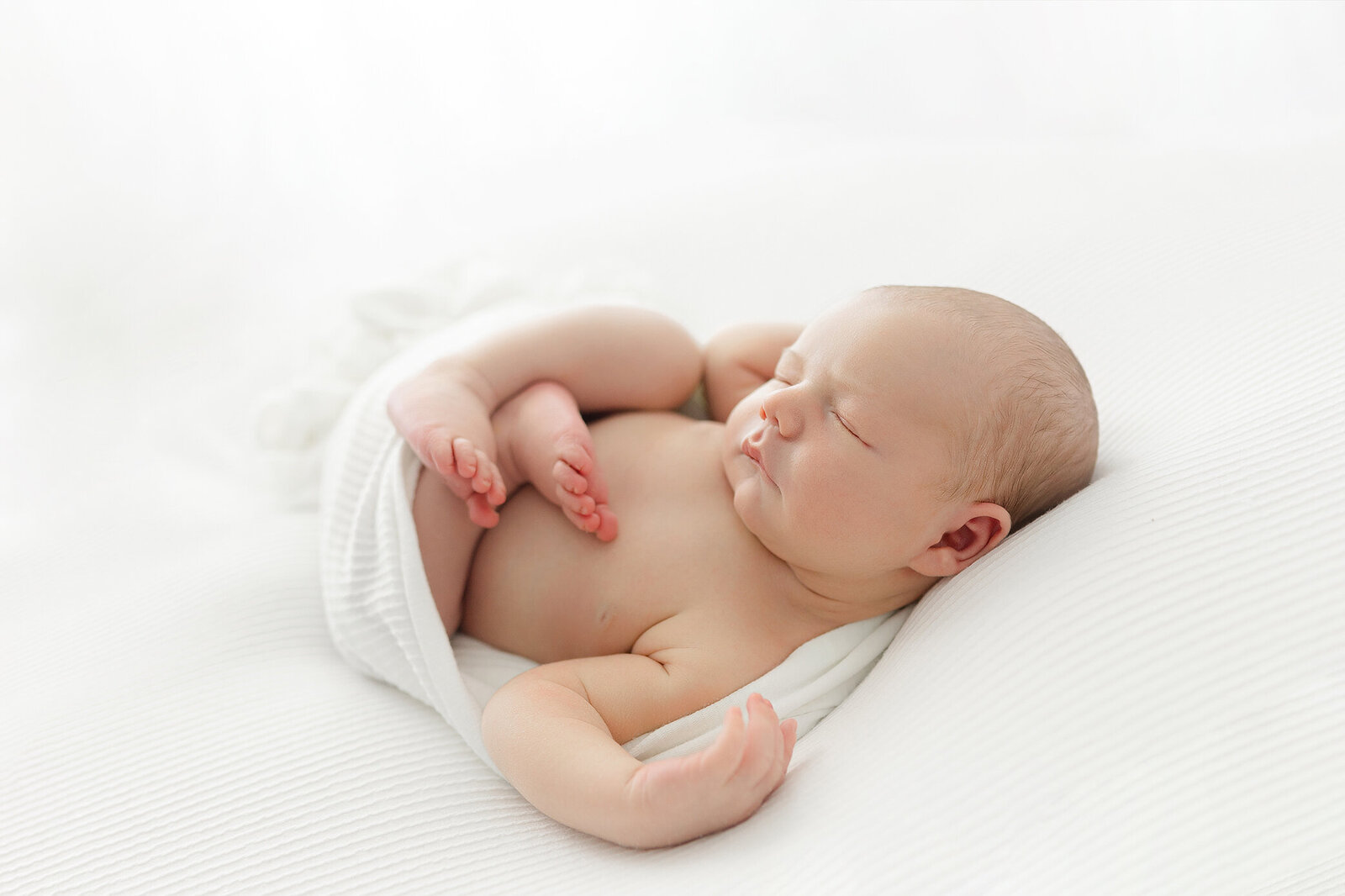 Newborn baby wrapped in white | timeless portrait by Chelsea Nichole Photography Grand Forks