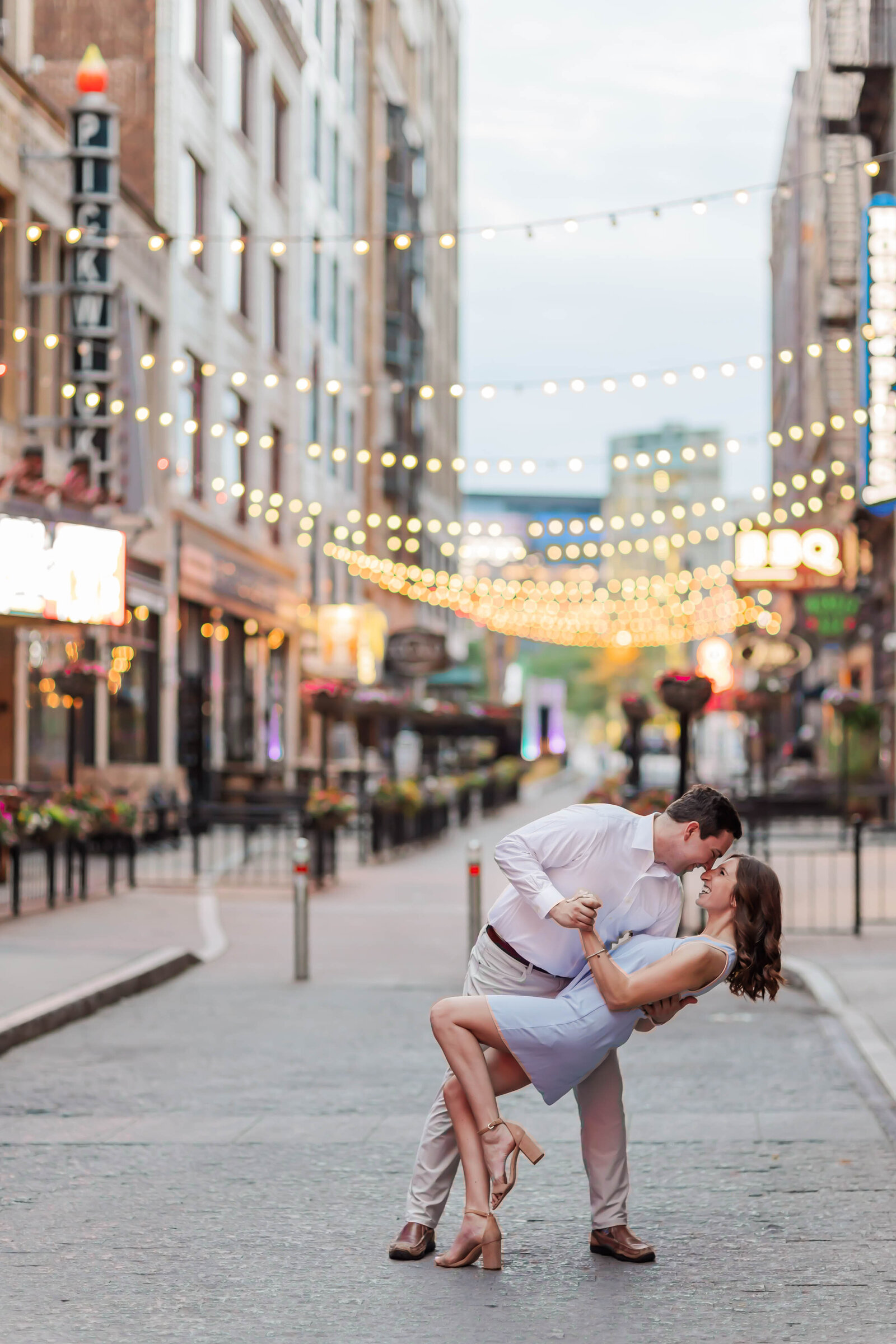 Couple celebrating their engagement on quiet streets.