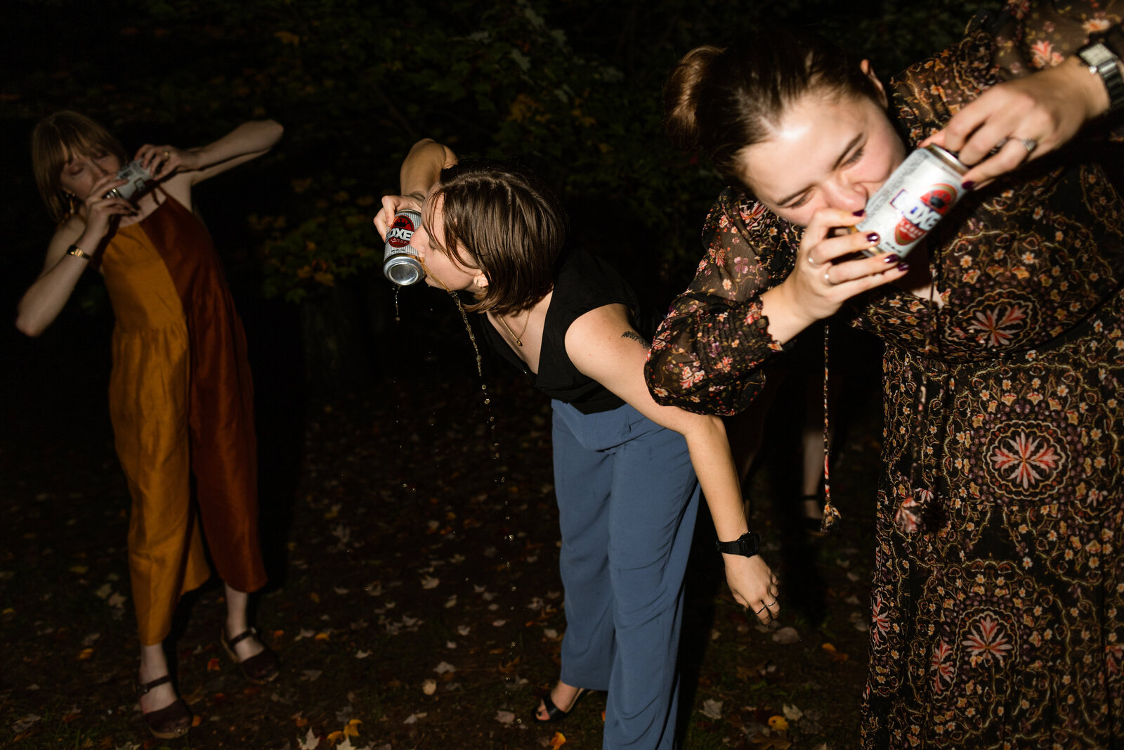 A group of friends reliving an old college tradition at a summer camp wedding in the woods