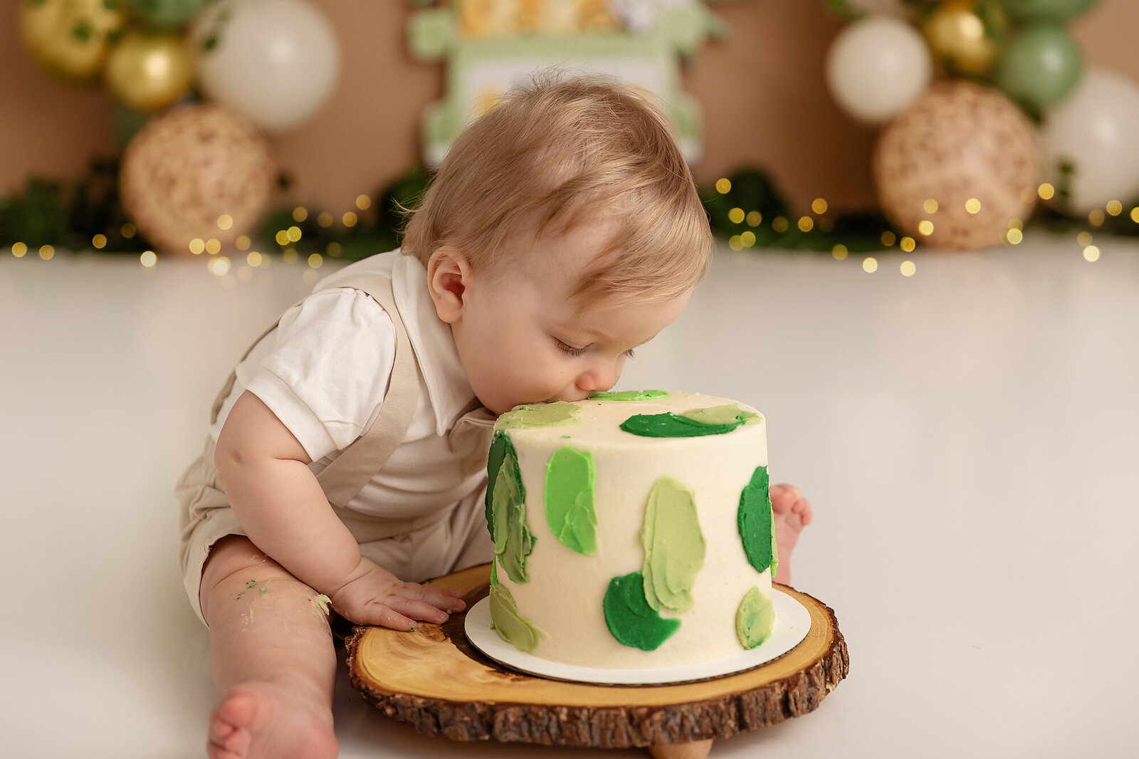 baby eating cake with green splotches