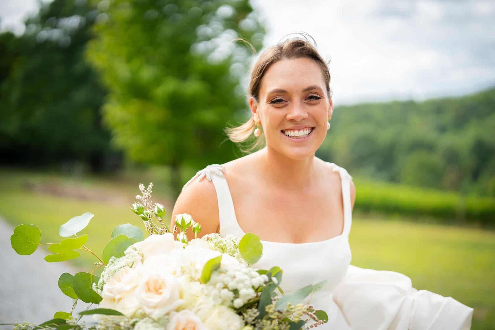 Allie, the bride running through the vineyard on her wedding day in the north GA mountains
