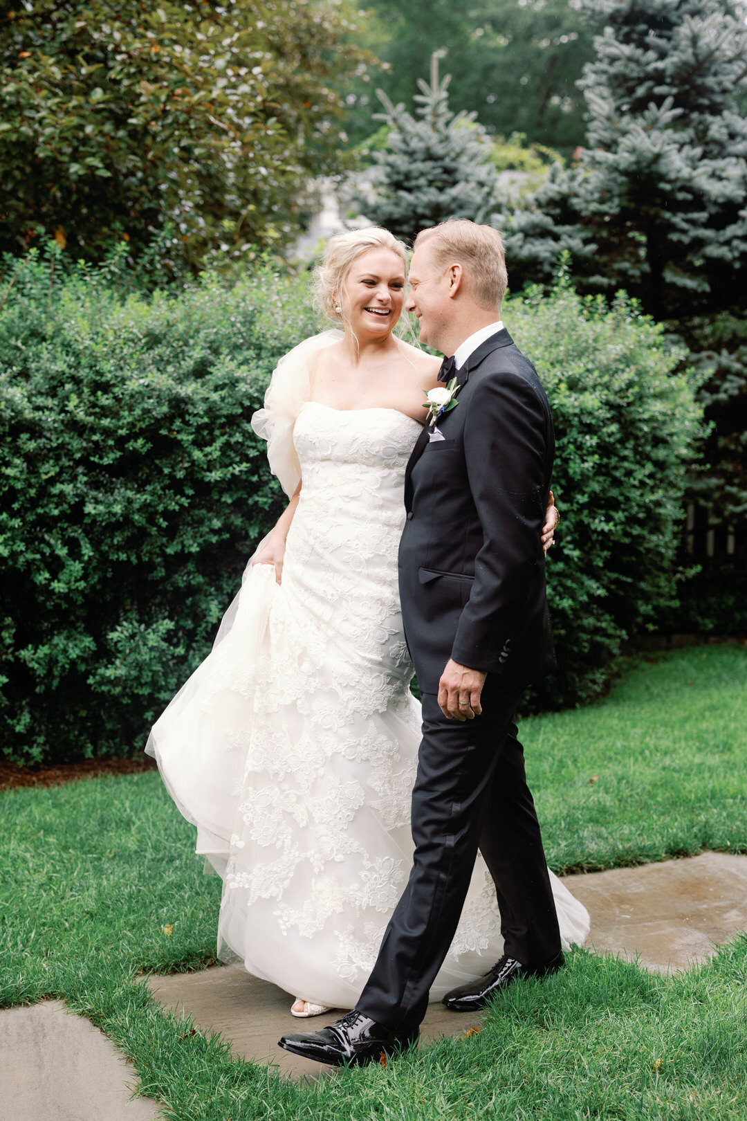 bride and groom walking on path at The Farm at Old Edwards Inn