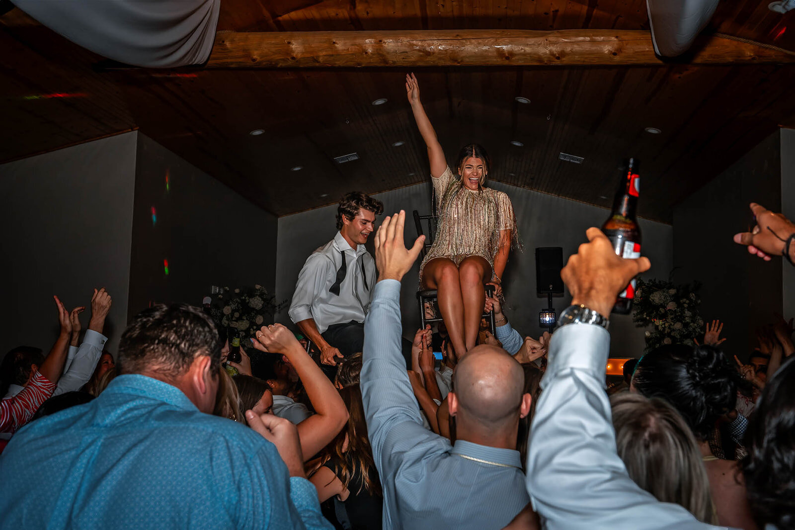 Guests having a blast on the dance floor during a luxury San Antonio wedding, captured in candid style by CMH Studios.