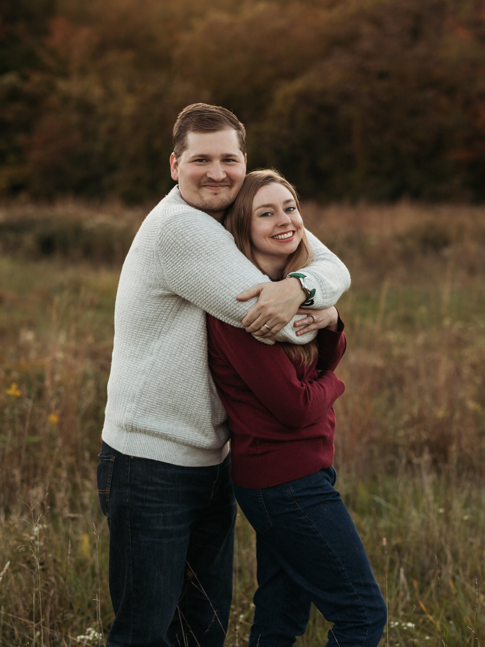 husband and wife hugging for family photos 