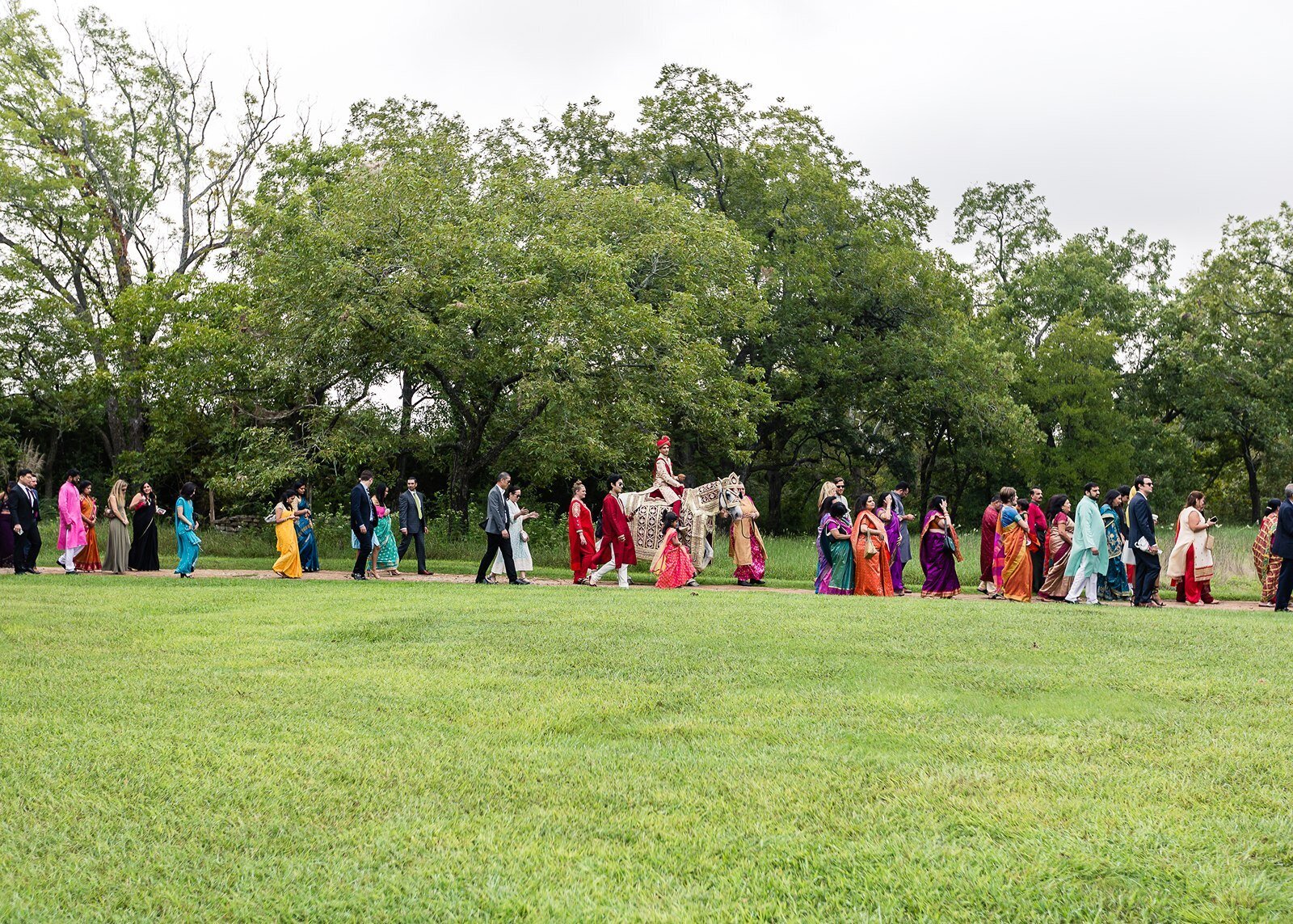 Indian wedding procession outside hill country wedding venue