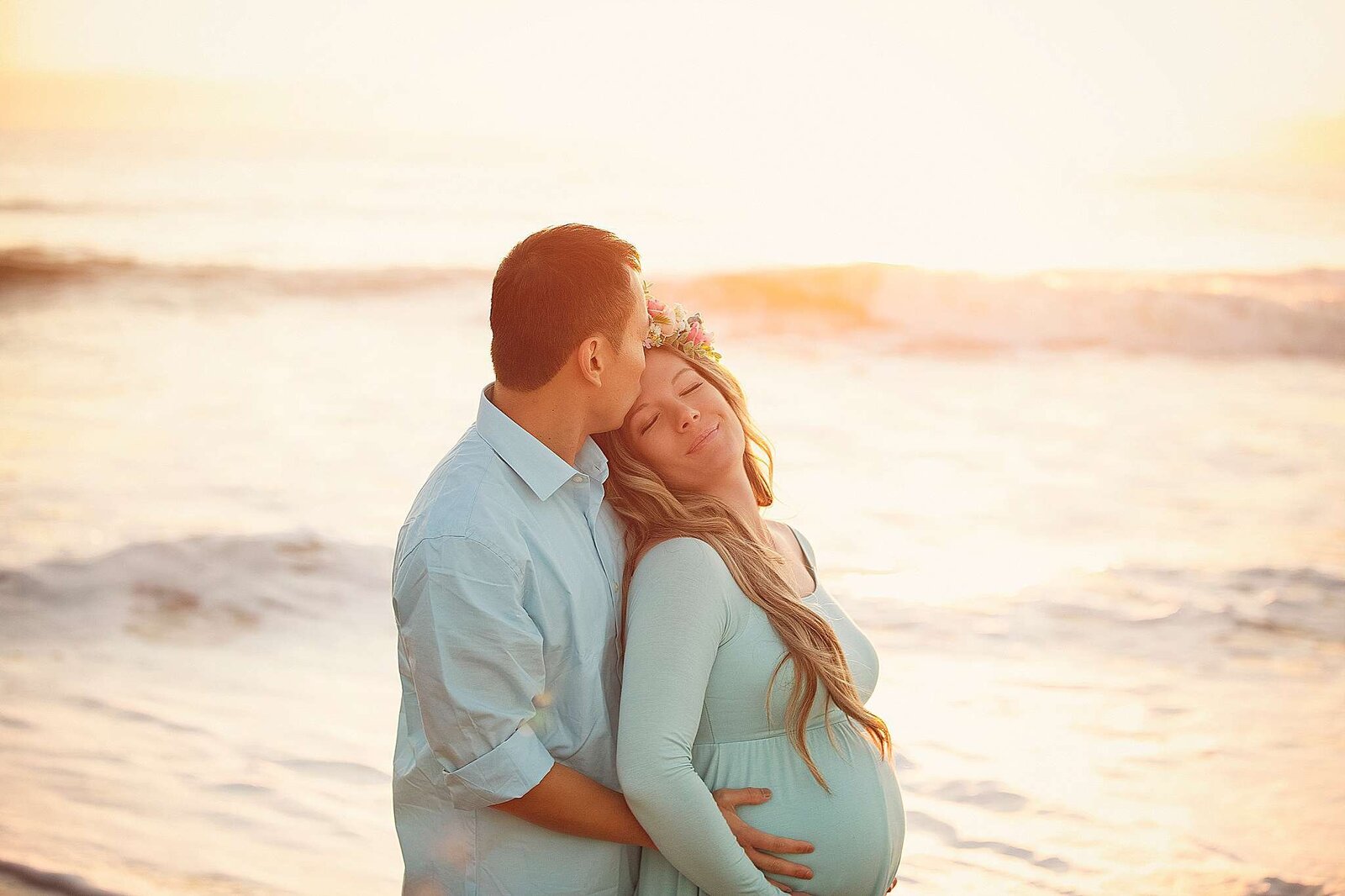 Maternity photography session at sunrise in Cocoa Beach, FL, by Bia Schaefer, capturing beautiful moments of motherhood.