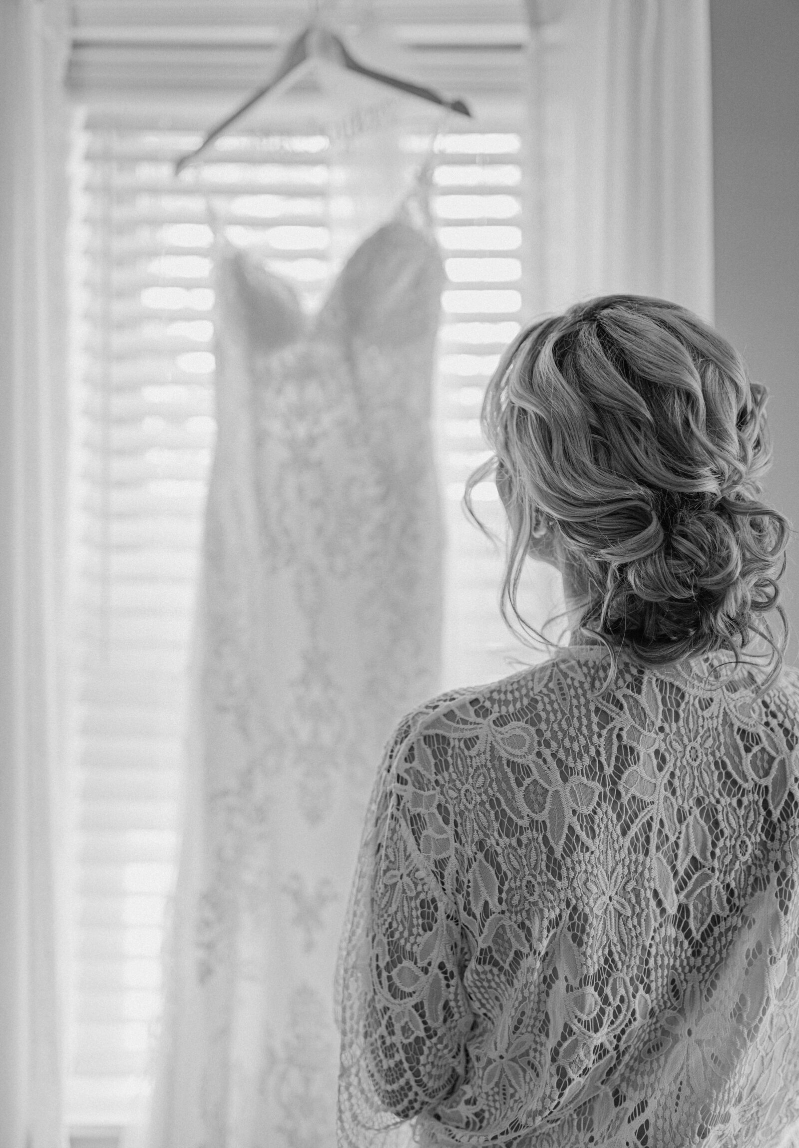bride admiring her dress during getting ready photos before first look delaware wedding photography