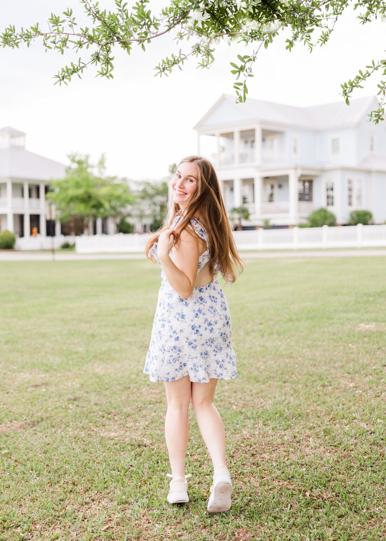 Sophie twirling in a field with a charming blue and white floral dress, photographed by Abby Bell Photography, Fine Art Portrait Photographer based in Alabama.