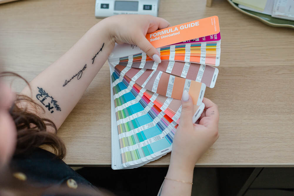 Color image of a creator looking at color wheel