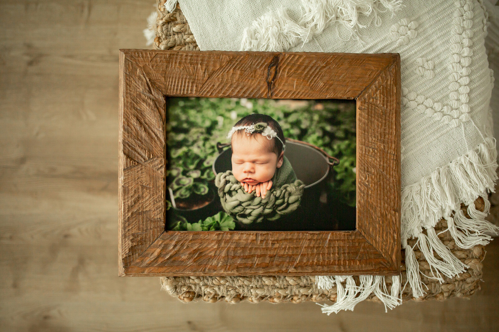 newborn garden photo in a wooden frame